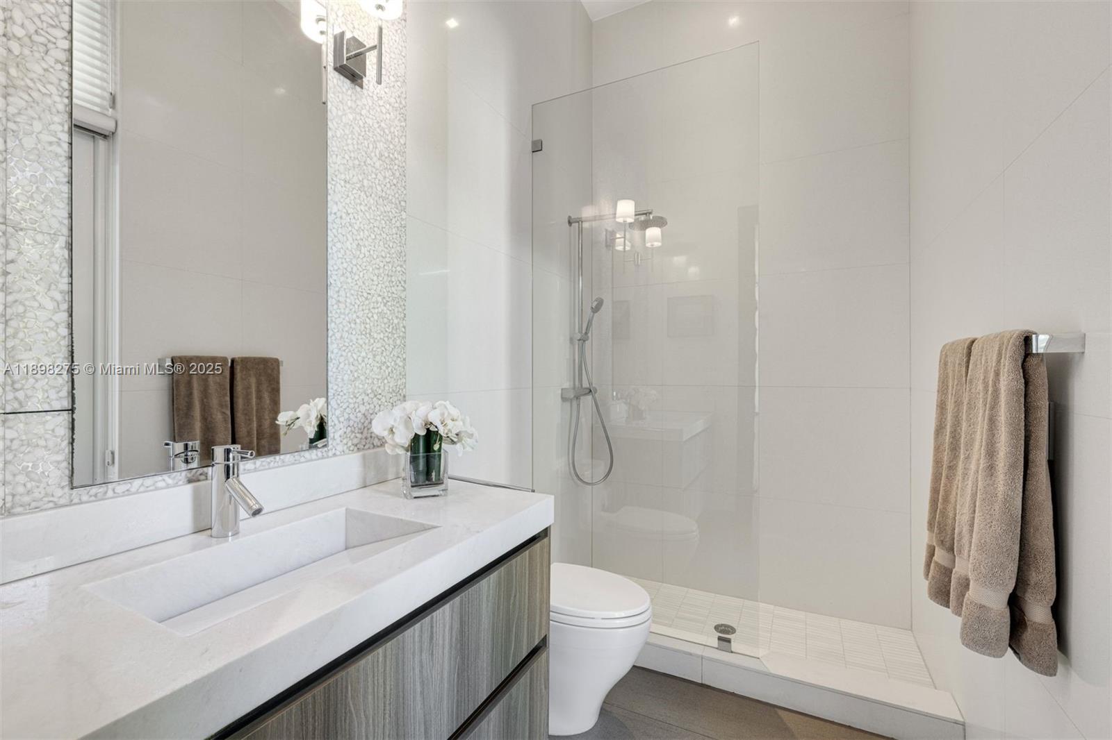 765 Allendale Road Key Biscayne, FL 33149 - Photo 8 of 29 a bathroom with a sink a toilet and shower