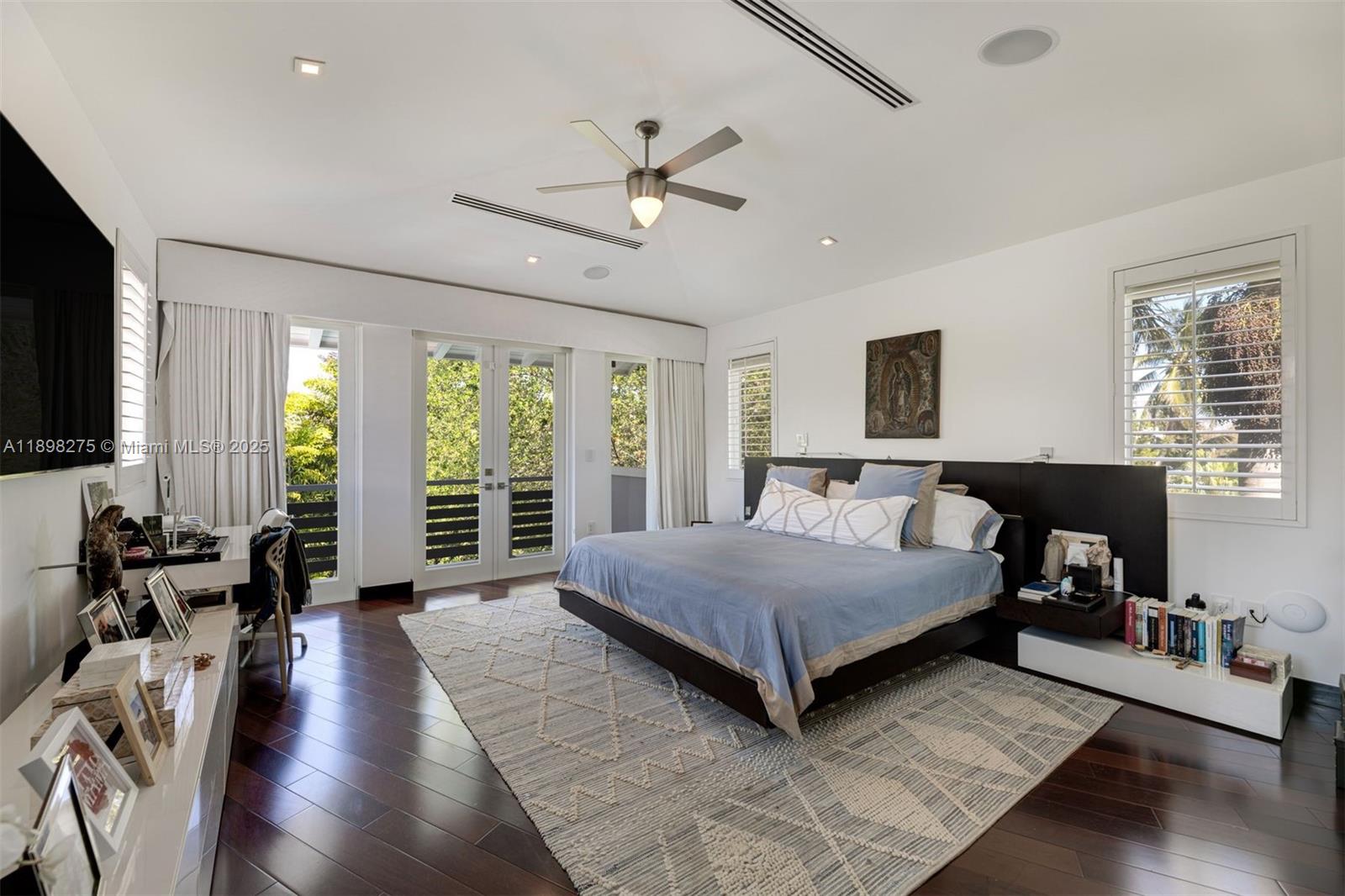 765 Allendale Road Key Biscayne, FL 33149 - Photo 10 of 29 a spacious bedroom with a large bed and a large window