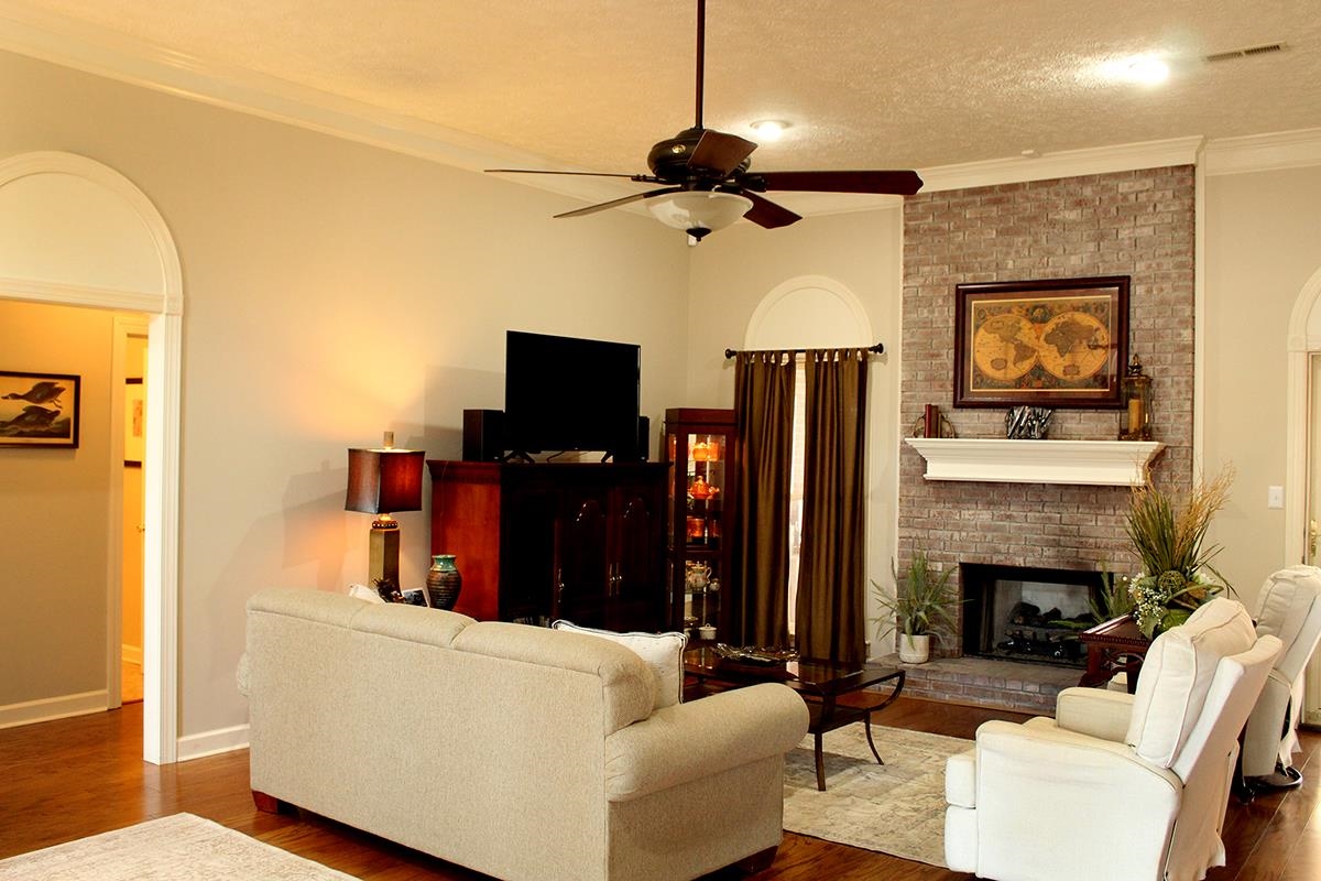 175 Windale Drive Jackson, TN 38305 - Photo 13 of 25 a living room with furniture a fireplace and a flat screen tv