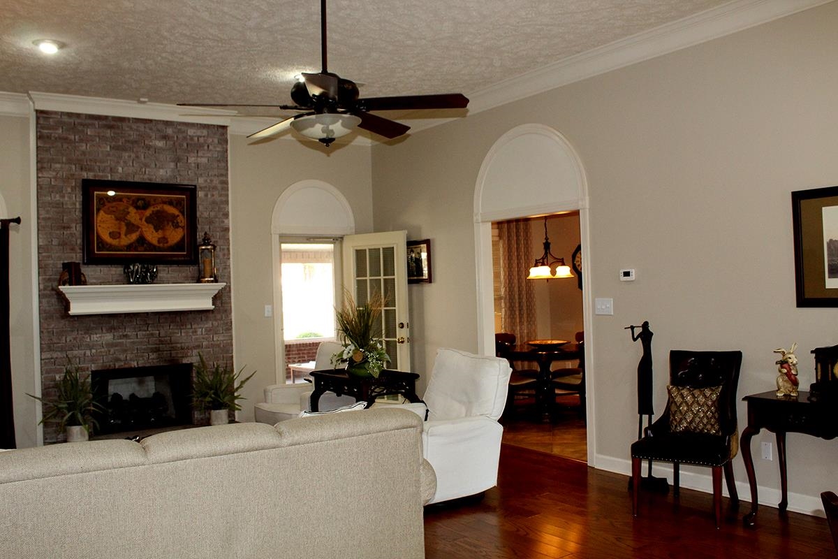 175 Windale Drive Jackson, TN 38305 - Photo 15 of 25 a living room with furniture a fireplace and wooden floor