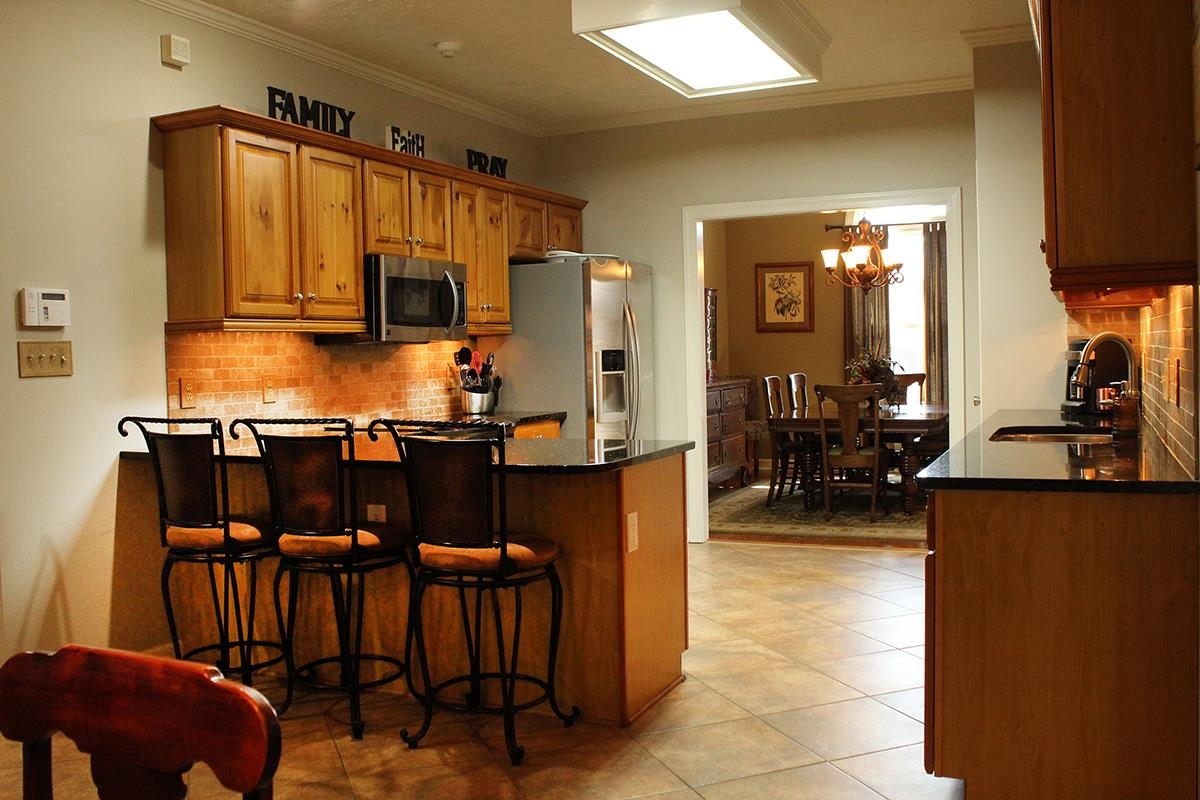 175 Windale Drive Jackson, TN 38305 - Photo 17 of 25 a kitchen with cabinets a sink and chairs
