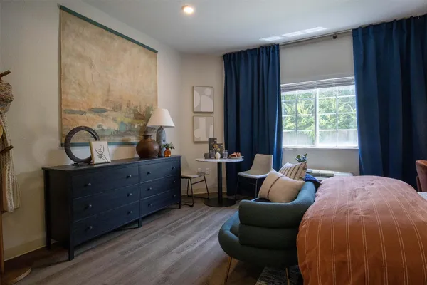 a bed room with furniture and a window