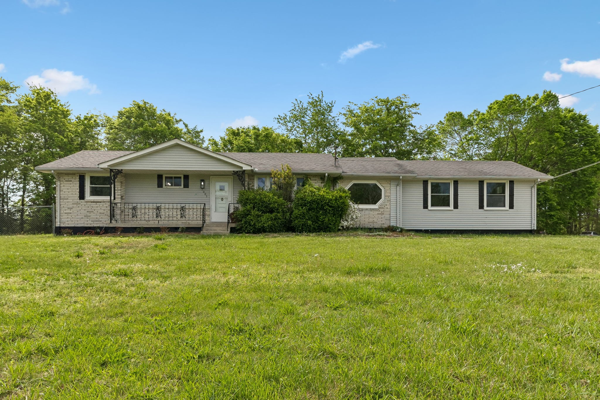 1003 Twin Creek Road Charlotte, TN 37036 - Photo 1 of 37 a front view of a house with a garden