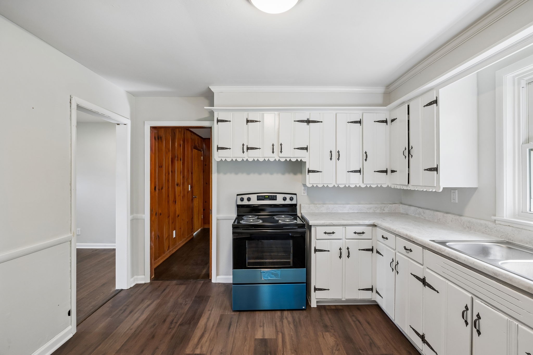 1003 Twin Creek Road Charlotte, TN 37036 - Photo 12 of 37 a kitchen with wooden floors and appliances