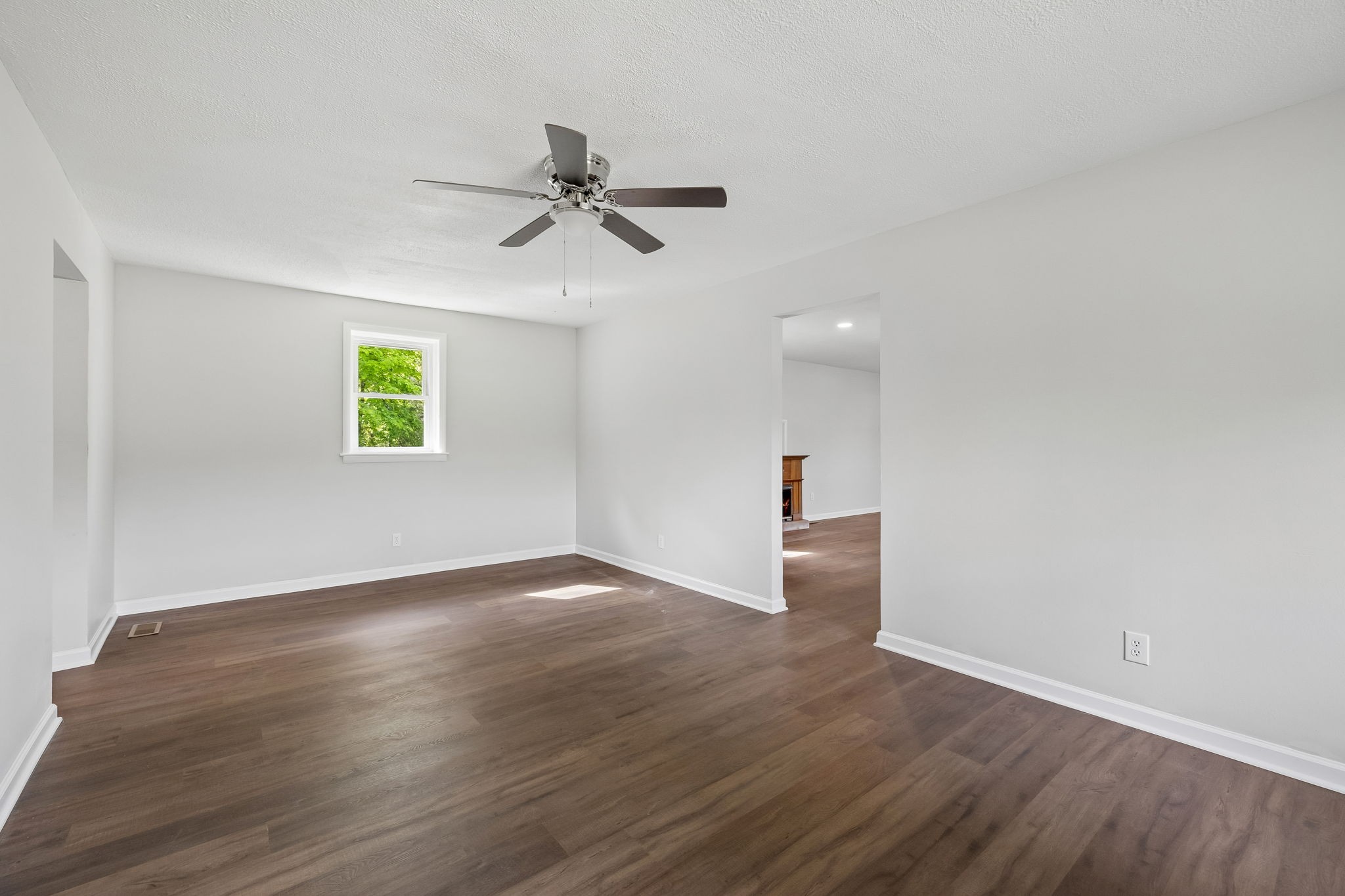 1003 Twin Creek Road Charlotte, TN 37036 - Photo 14 of 37 a view of an empty room with wooden floor and a window