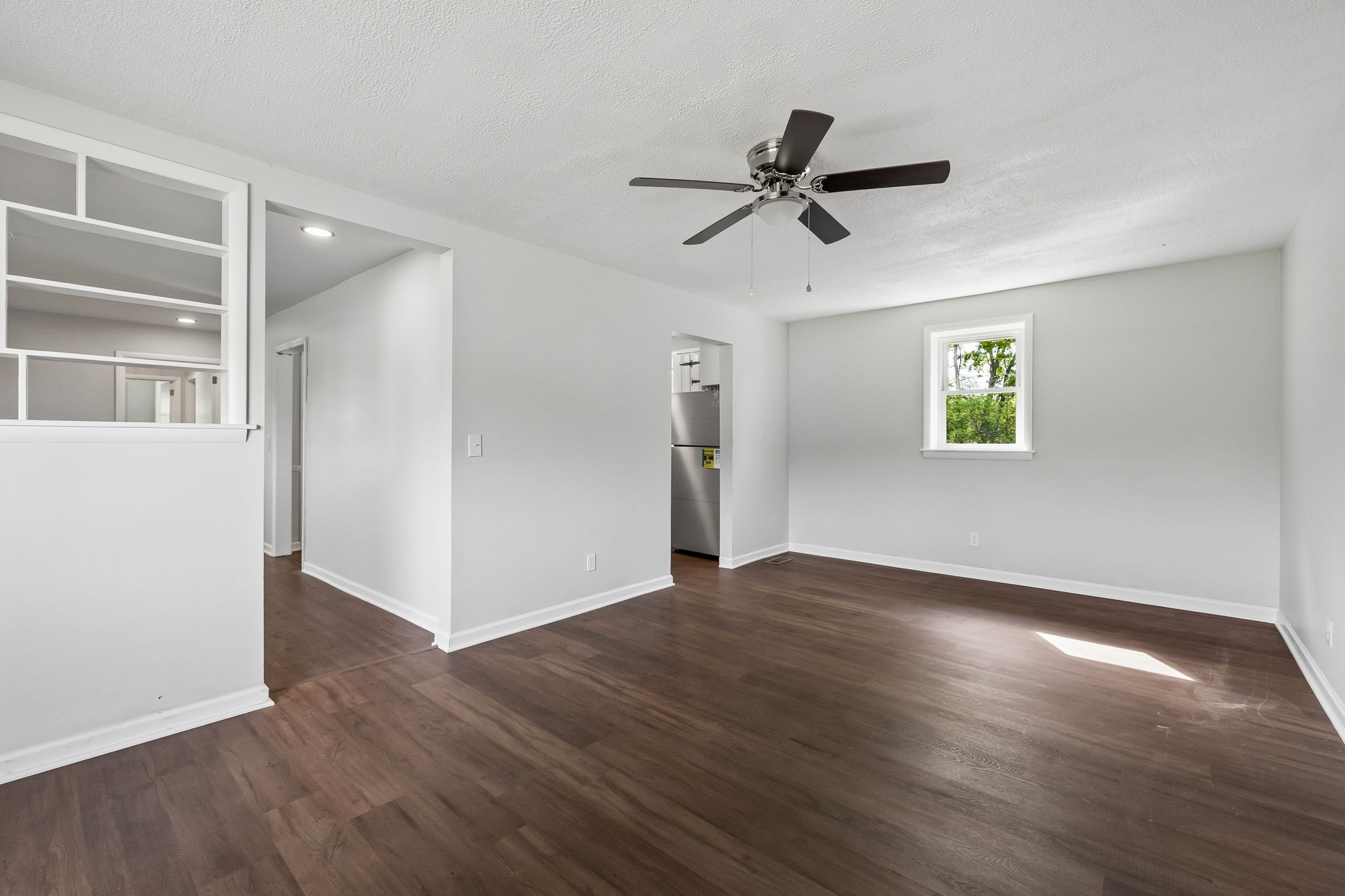 1003 Twin Creek Road Charlotte, TN 37036 - Photo 16 of 37 a view of empty room with wooden floor and fan