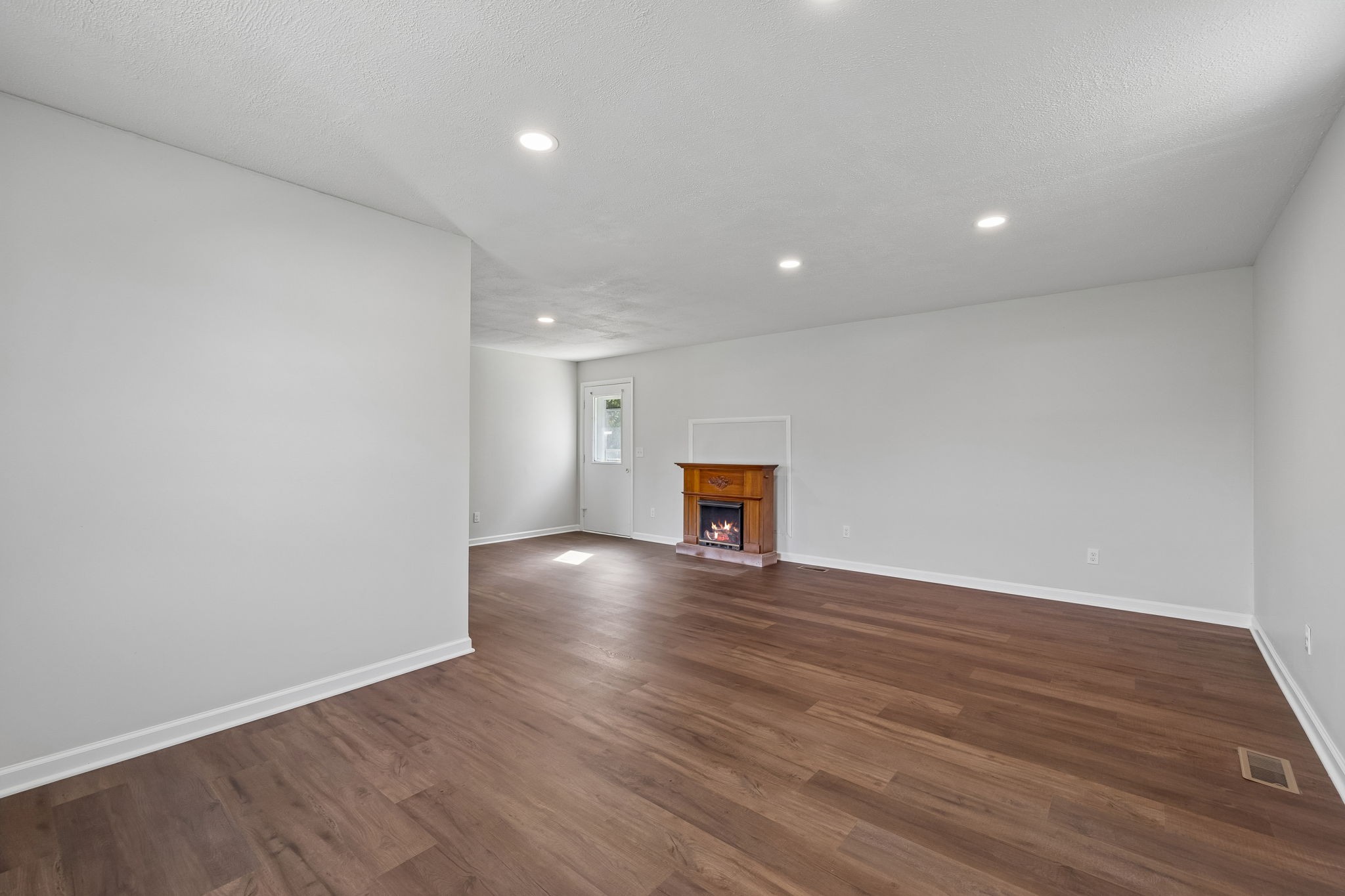 1003 Twin Creek Road Charlotte, TN 37036 - Photo 17 of 37 a view of an empty room with wooden floor and a window