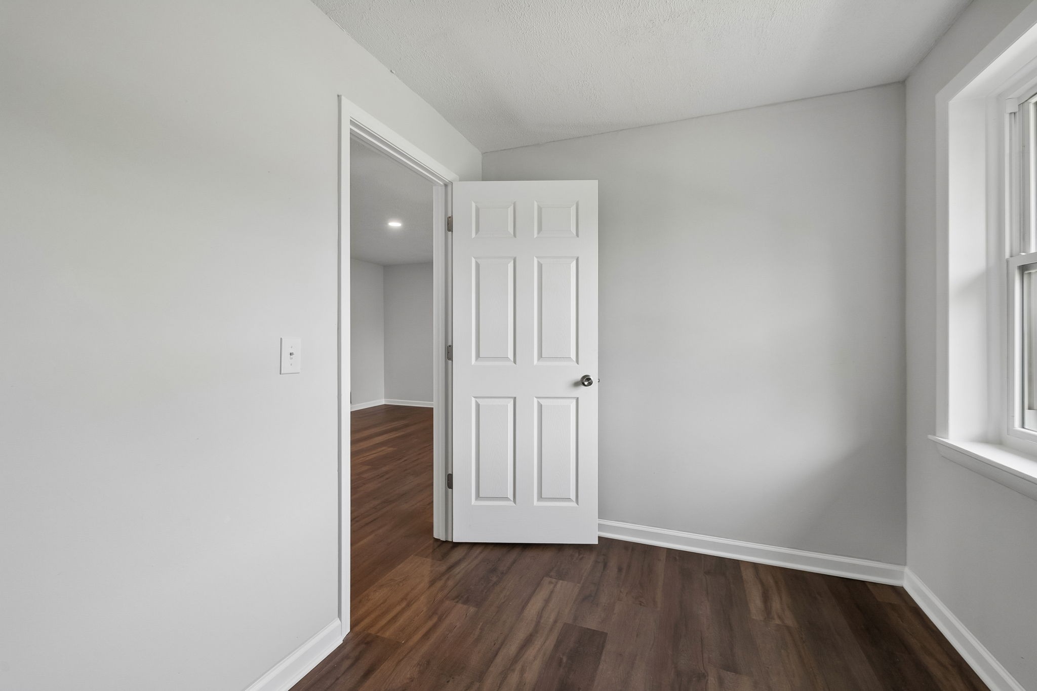 1003 Twin Creek Road Charlotte, TN 37036 - Photo 22 of 37 an empty room with wooden floor and windows