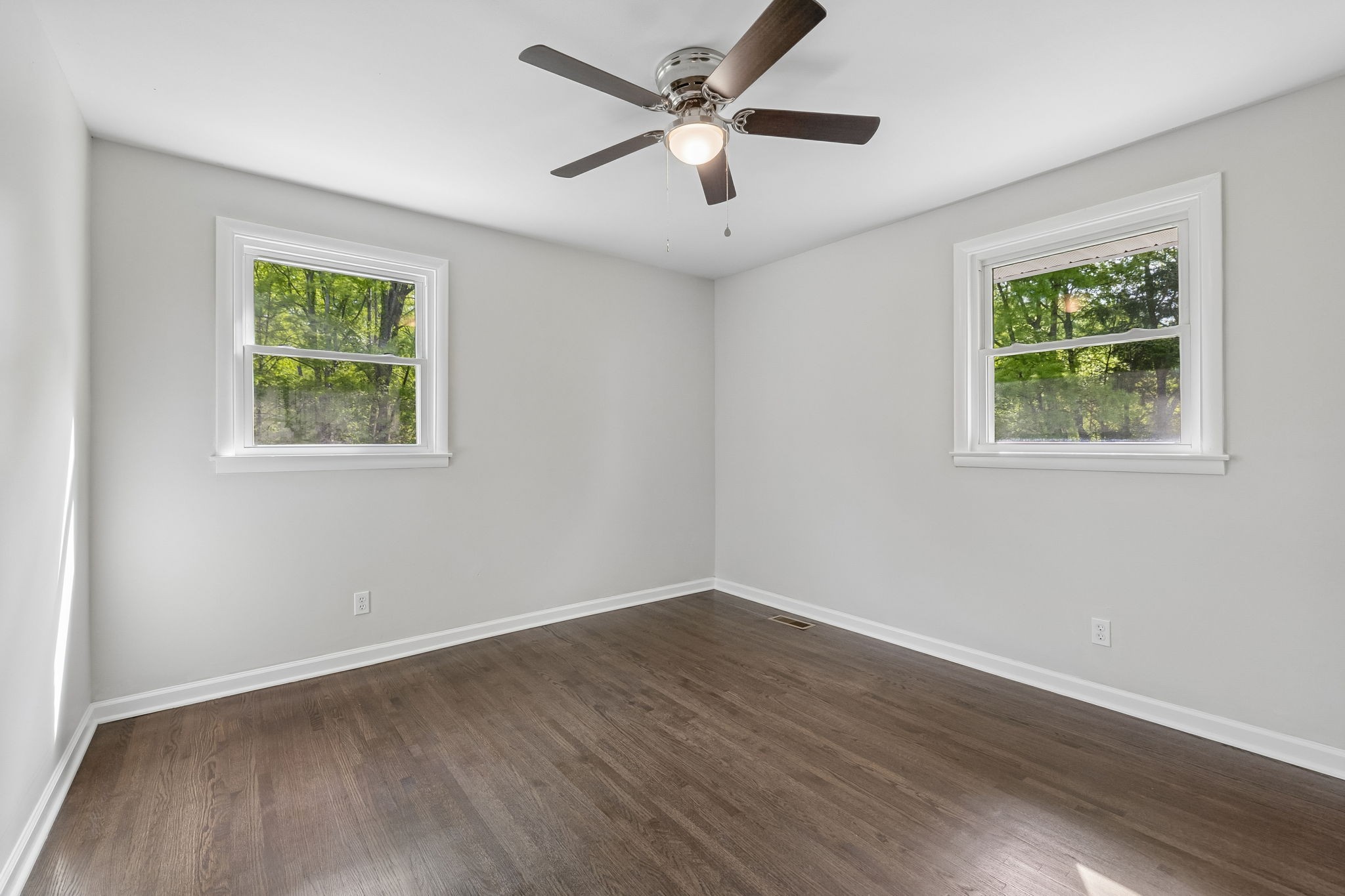 1003 Twin Creek Road Charlotte, TN 37036 - Photo 30 of 37 a view of an empty room with wooden floor and a ceiling fan