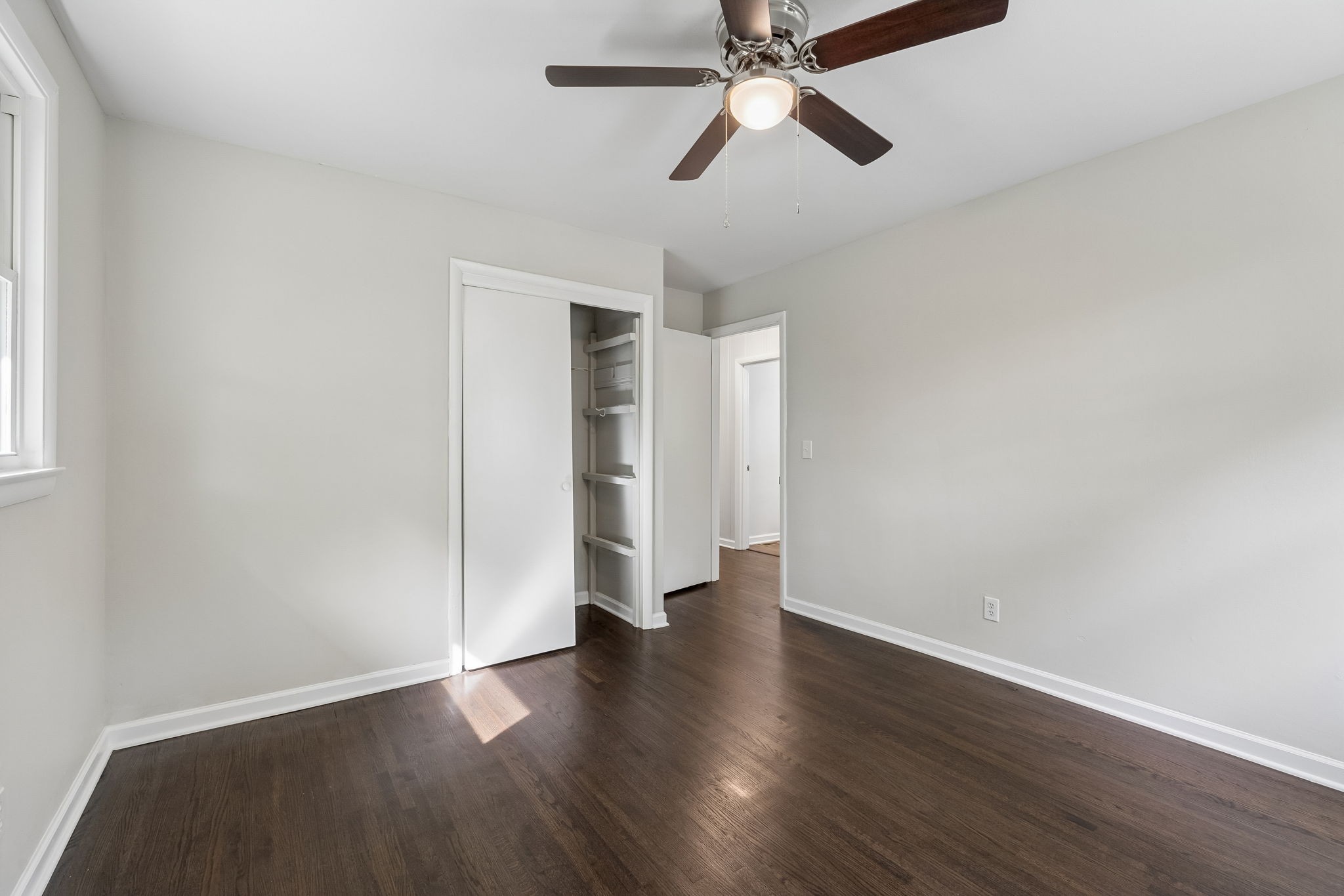 1003 Twin Creek Road Charlotte, TN 37036 - Photo 31 of 37 an empty room with wooden floor closet and windows