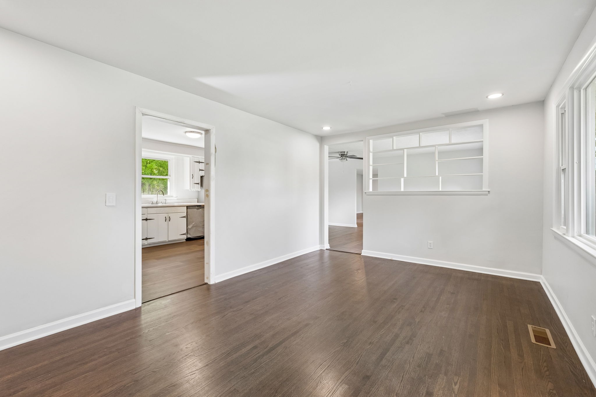 1003 Twin Creek Road Charlotte, TN 37036 - Photo 4 of 37 a view of an empty room with wooden floor and a window