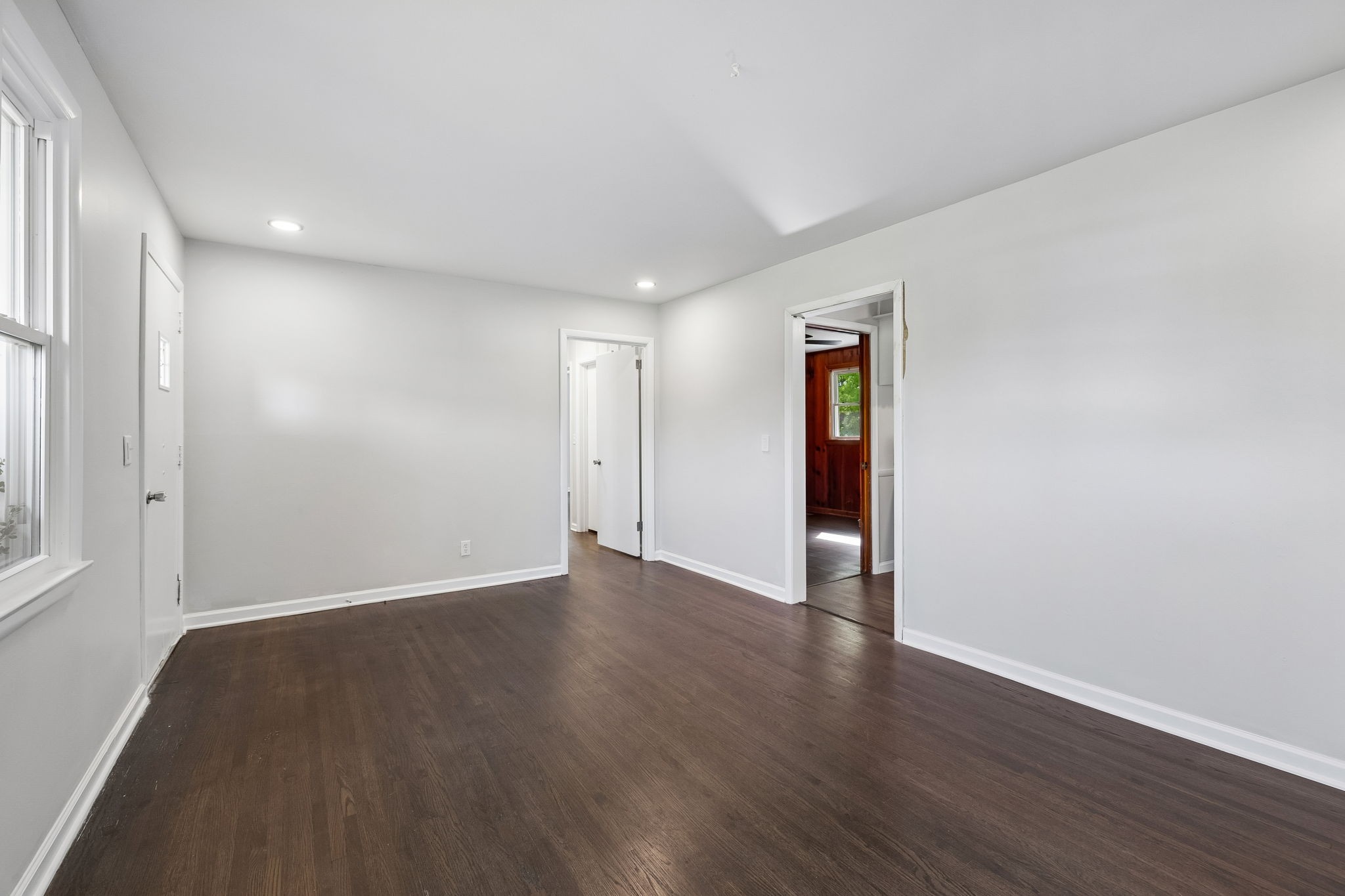 1003 Twin Creek Road Charlotte, TN 37036 - Photo 5 of 37 an empty room with wooden floor and windows