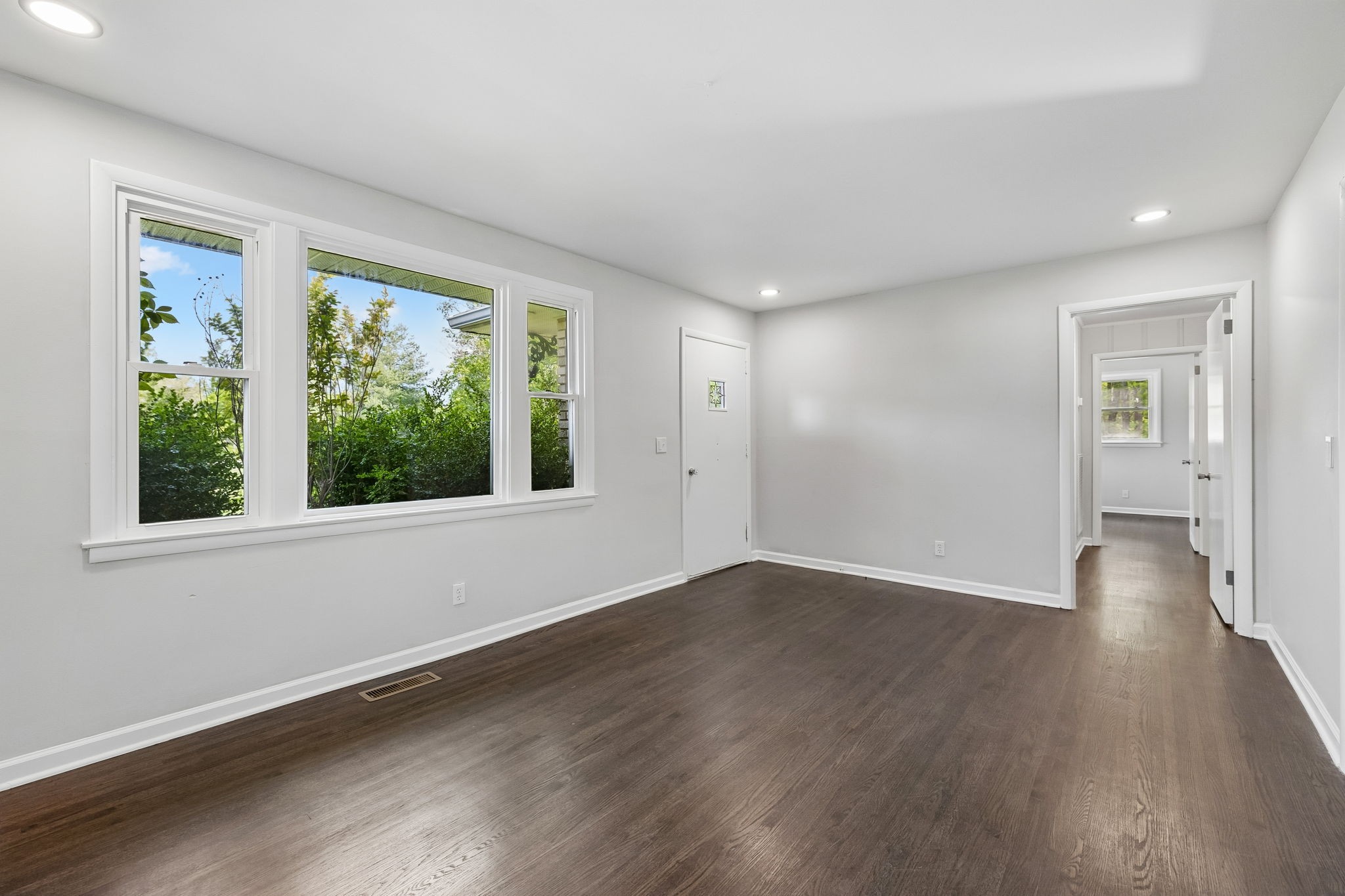 1003 Twin Creek Road Charlotte, TN 37036 - Photo 6 of 37 a view of an empty room with wooden floor and a window