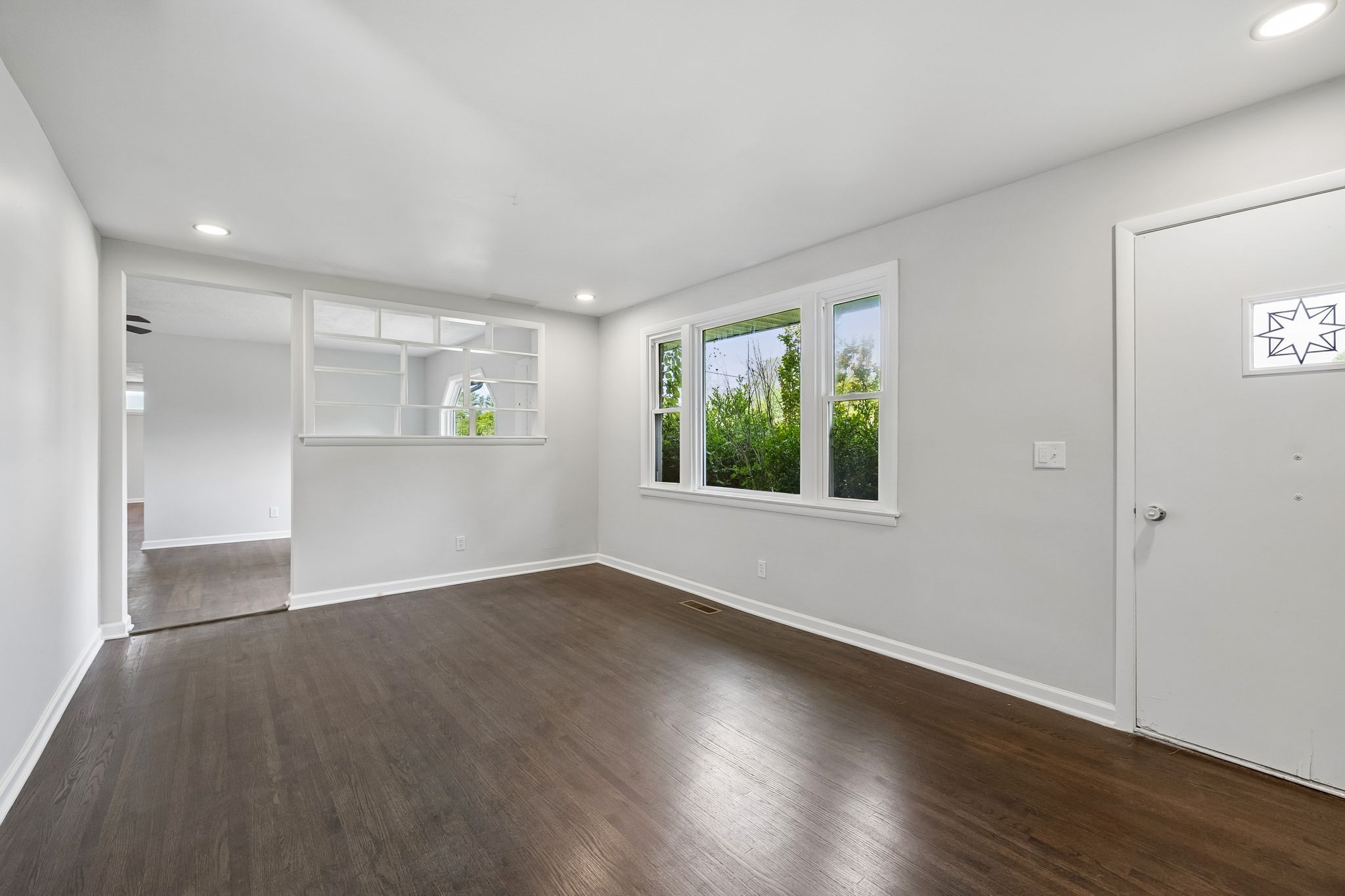 1003 Twin Creek Road Charlotte, TN 37036 - Photo 7 of 37 an empty room with wooden floor and windows