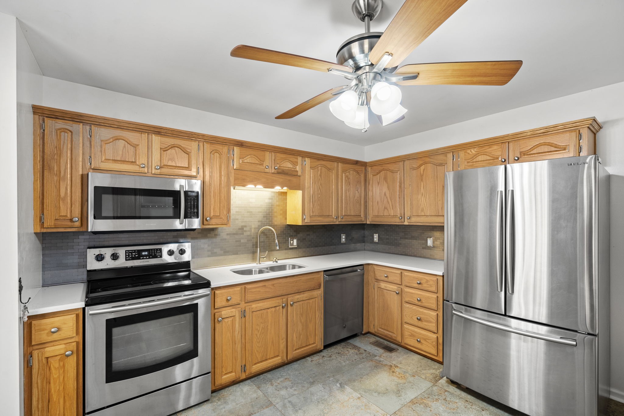 4985 Minnis Road Springfield, TN 37172 - Photo 54 of 58 a kitchen with a refrigerator a sink and wooden cabinets