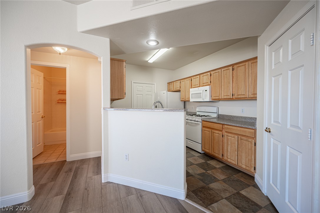 8555 West Russell Road, Unit 2062 Las Vegas, NV 89113 - Photo 13 of 35 A functional kitchen boasts light wood cabinetry and a convenient breakfast bar.