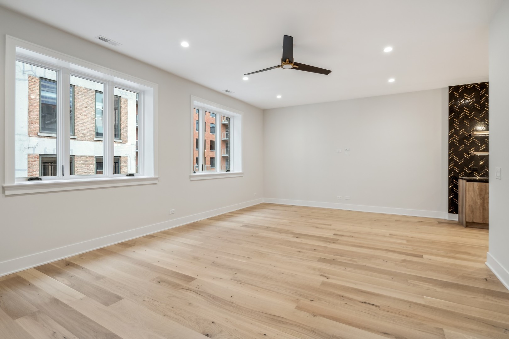 232 South Green Street, Unit 4S Chicago, IL 60607 - Photo 11 of 42 a view of an empty room with a window and wooden floor