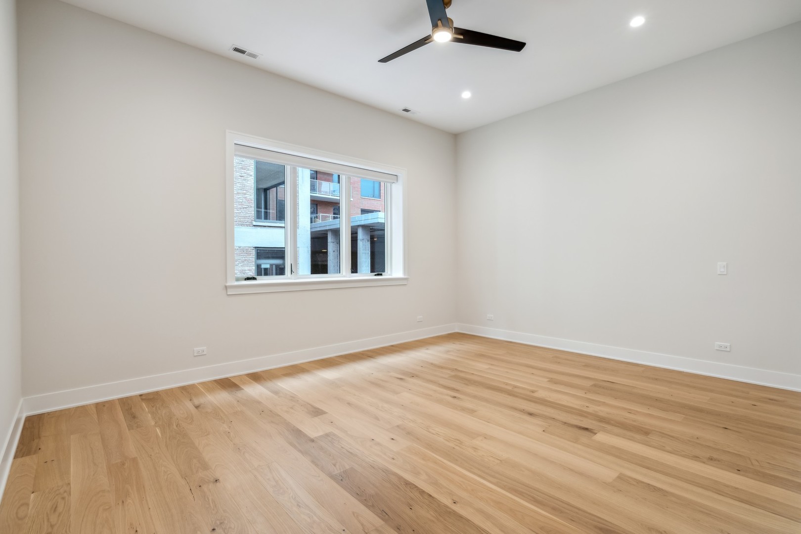232 South Green Street, Unit 4S Chicago, IL 60607 - Photo 16 of 42 an empty room with wooden floor fan and windows