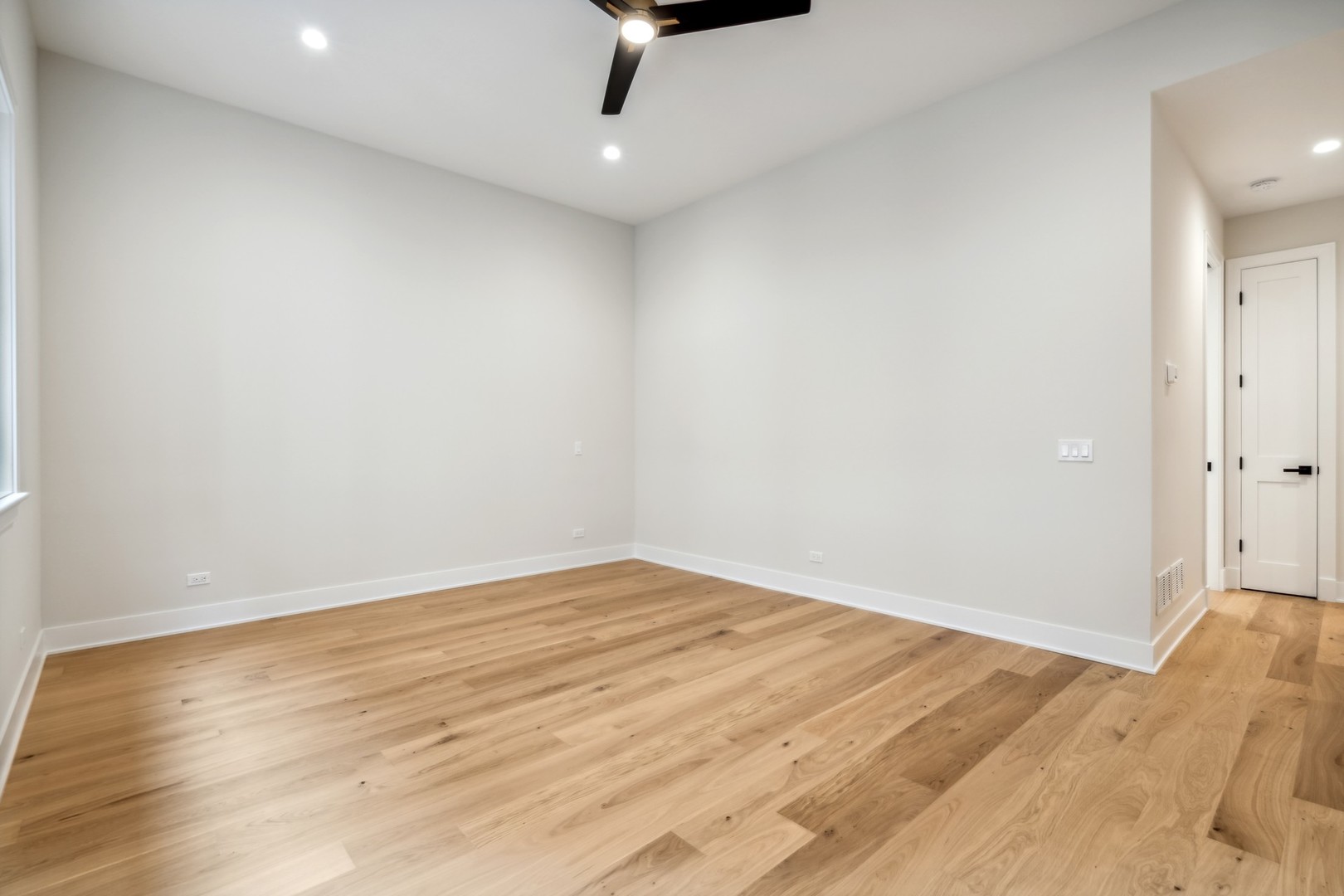 232 South Green Street, Unit 4S Chicago, IL 60607 - Photo 17 of 42 an empty room with wooden floor fan and windows