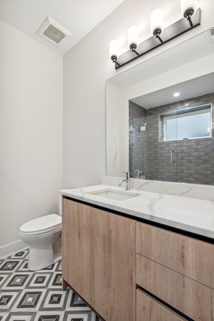 232 South Green Street, Unit 4S Chicago, IL 60607 - Photo 30 of 42 a bathroom with a toilet a sink and mirror