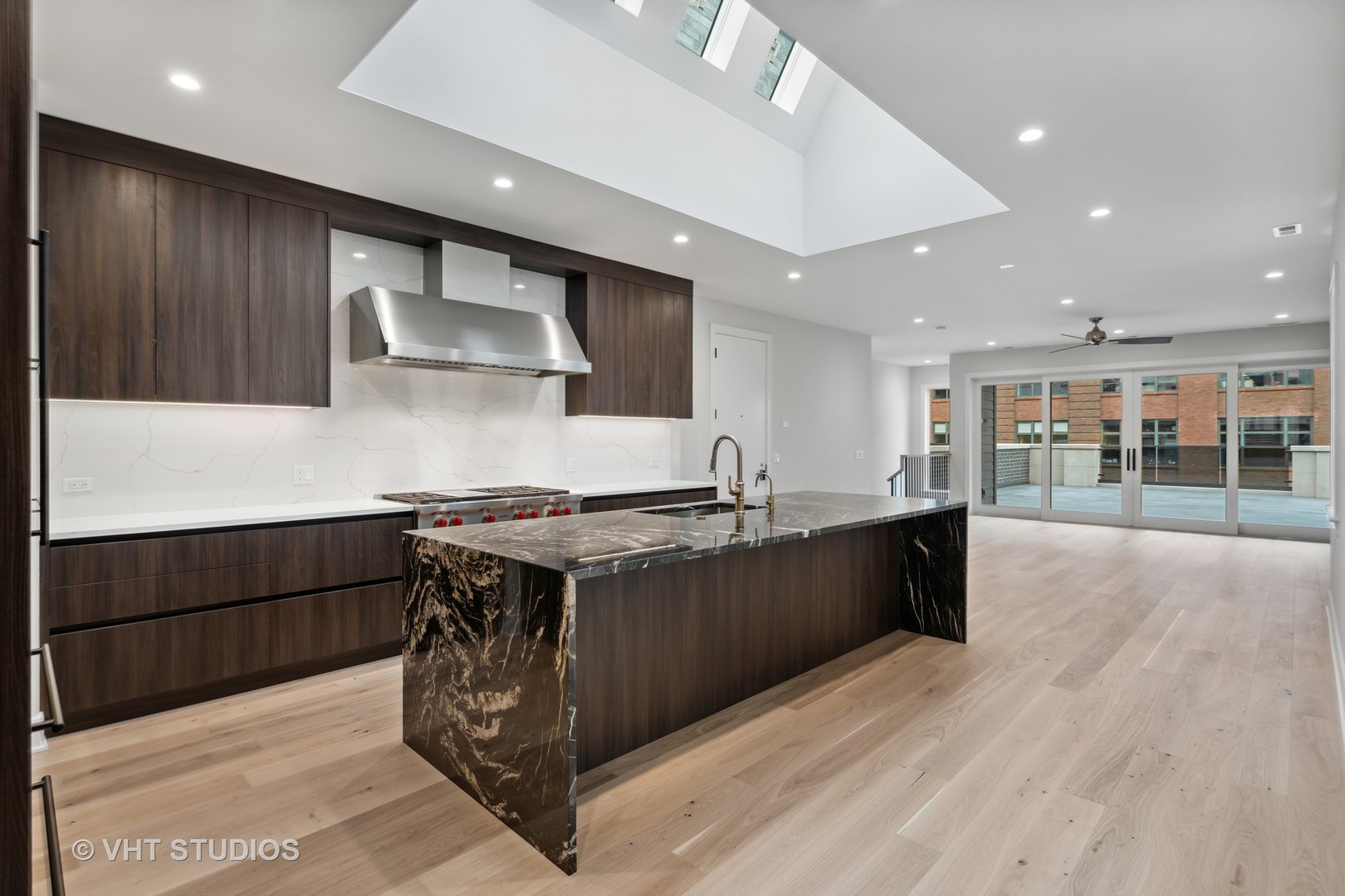 232 South Green Street, Unit 4S Chicago, IL 60607 - Photo 5 of 42 a kitchen with stainless steel appliances granite countertop a large stove a sink dishwasher and a refrigerator with wooden floor