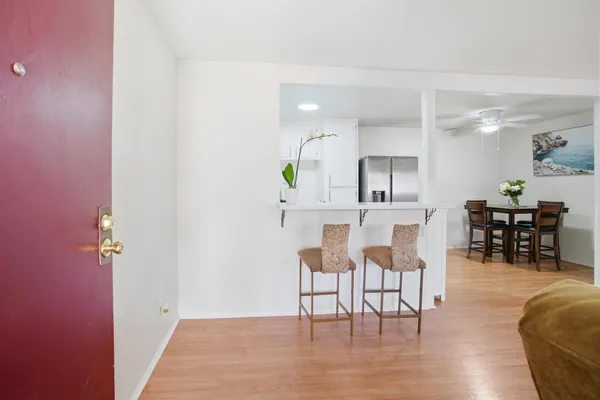 a living room with furniture and wooden floor
