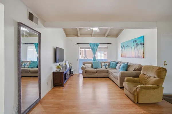 a view of a room with wooden floor
