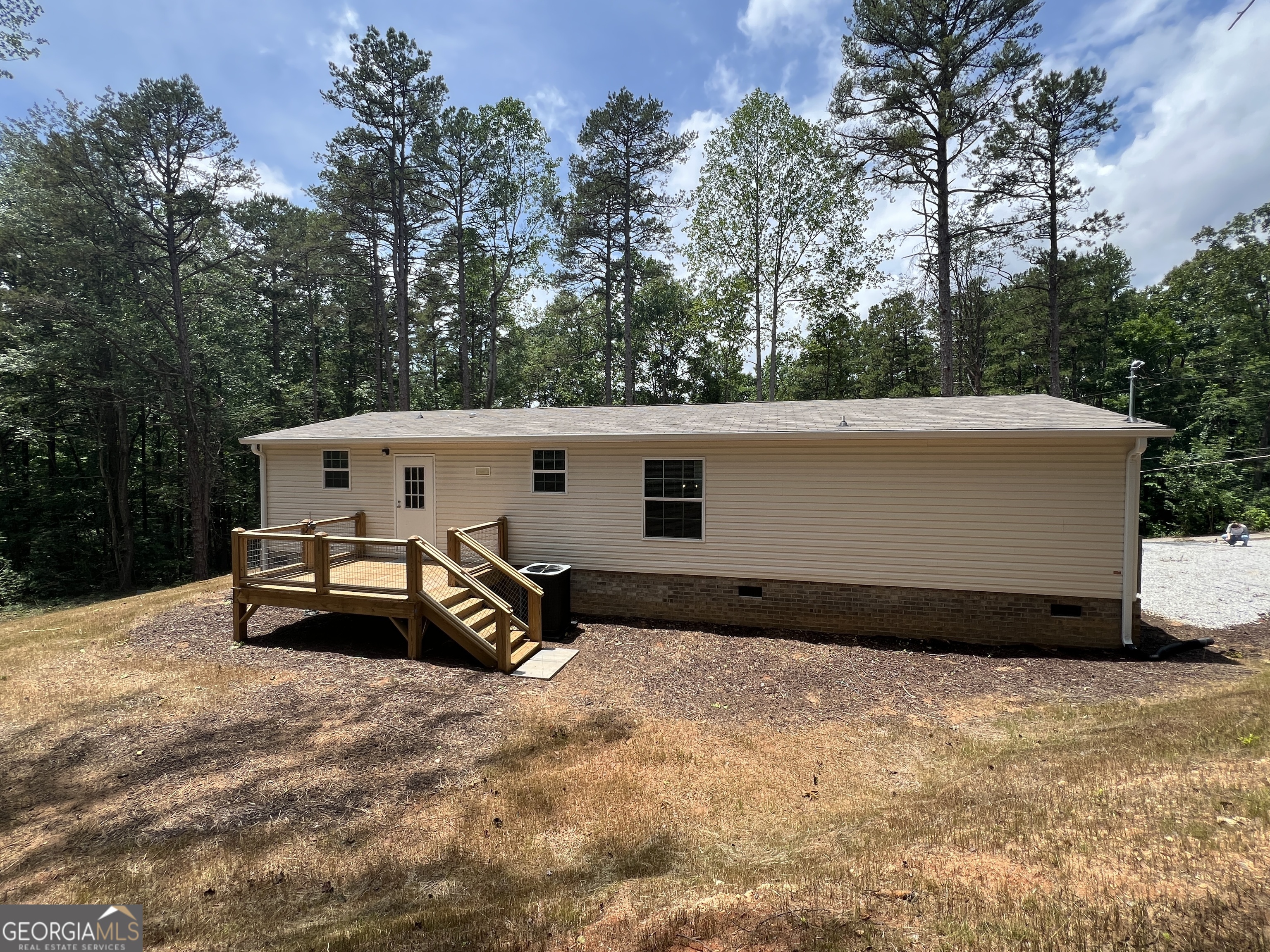 69 Cheyenne Trail Martin, GA 30557 - Photo 14 of 63 a view of a back yard of the house with a car parked