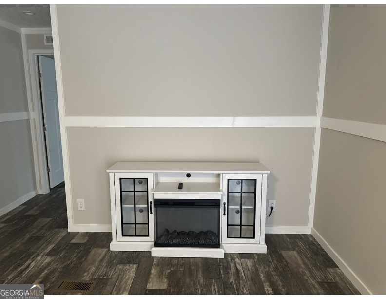 69 Cheyenne Trail Martin, GA 30557 - Photo 20 of 63 a view of an empty room with wooden floor and a window