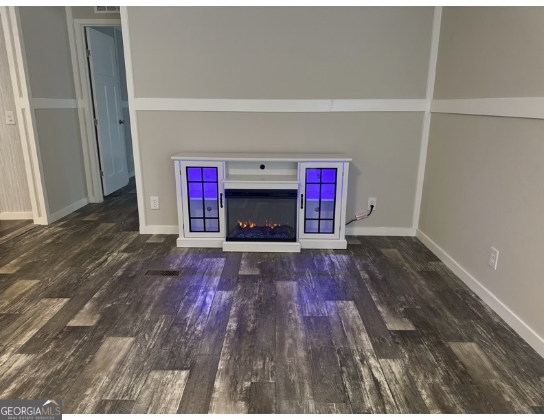 69 Cheyenne Trail Martin, GA 30557 - Photo 21 of 63 a view of empty room with wooden floor and fireplace