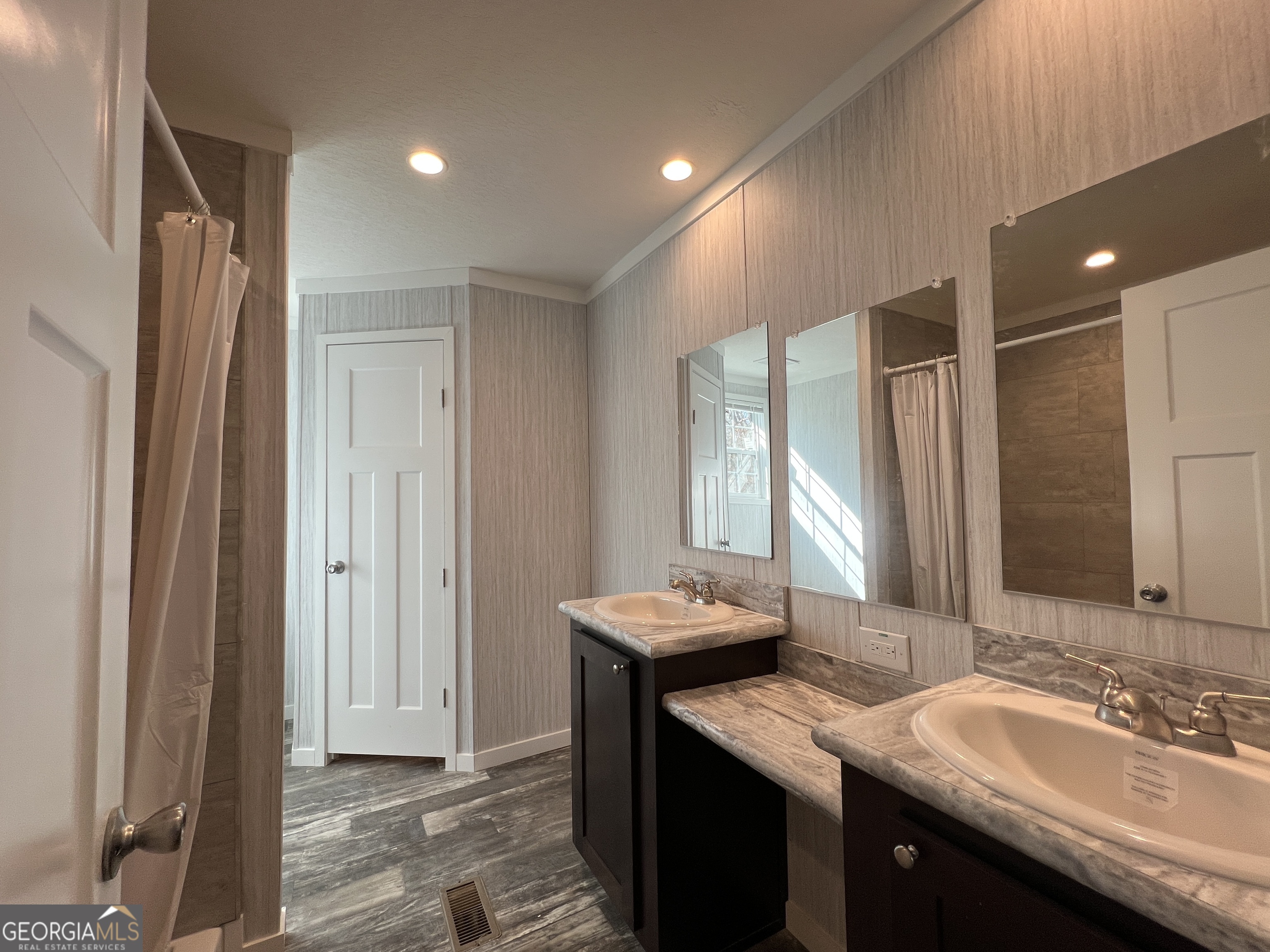 69 Cheyenne Trail Martin, GA 30557 - Photo 38 of 63 a bathroom with a granite countertop sink a large mirror and a shower