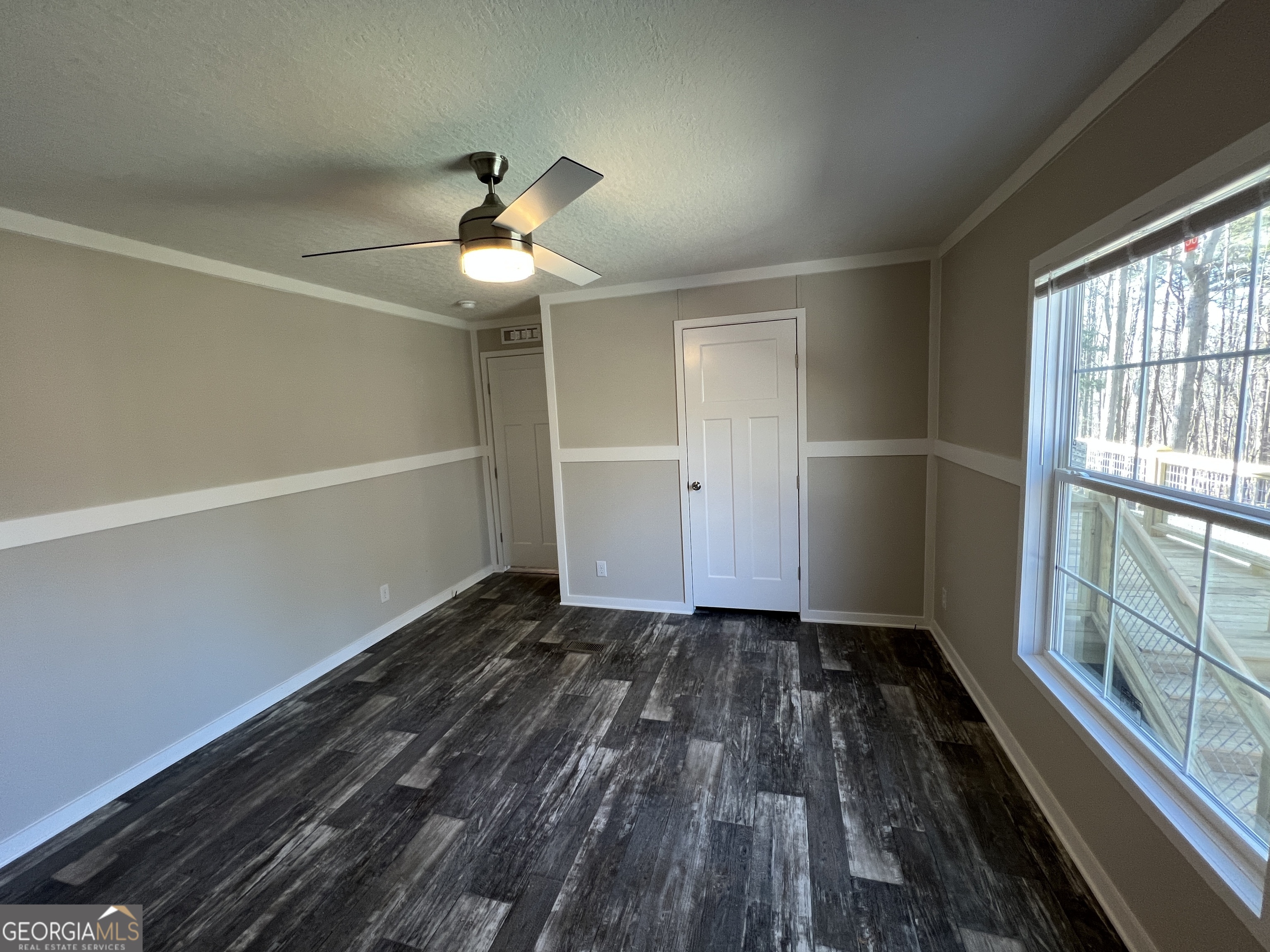 69 Cheyenne Trail Martin, GA 30557 - Photo 49 of 63 a view of empty room with wooden floor and fan
