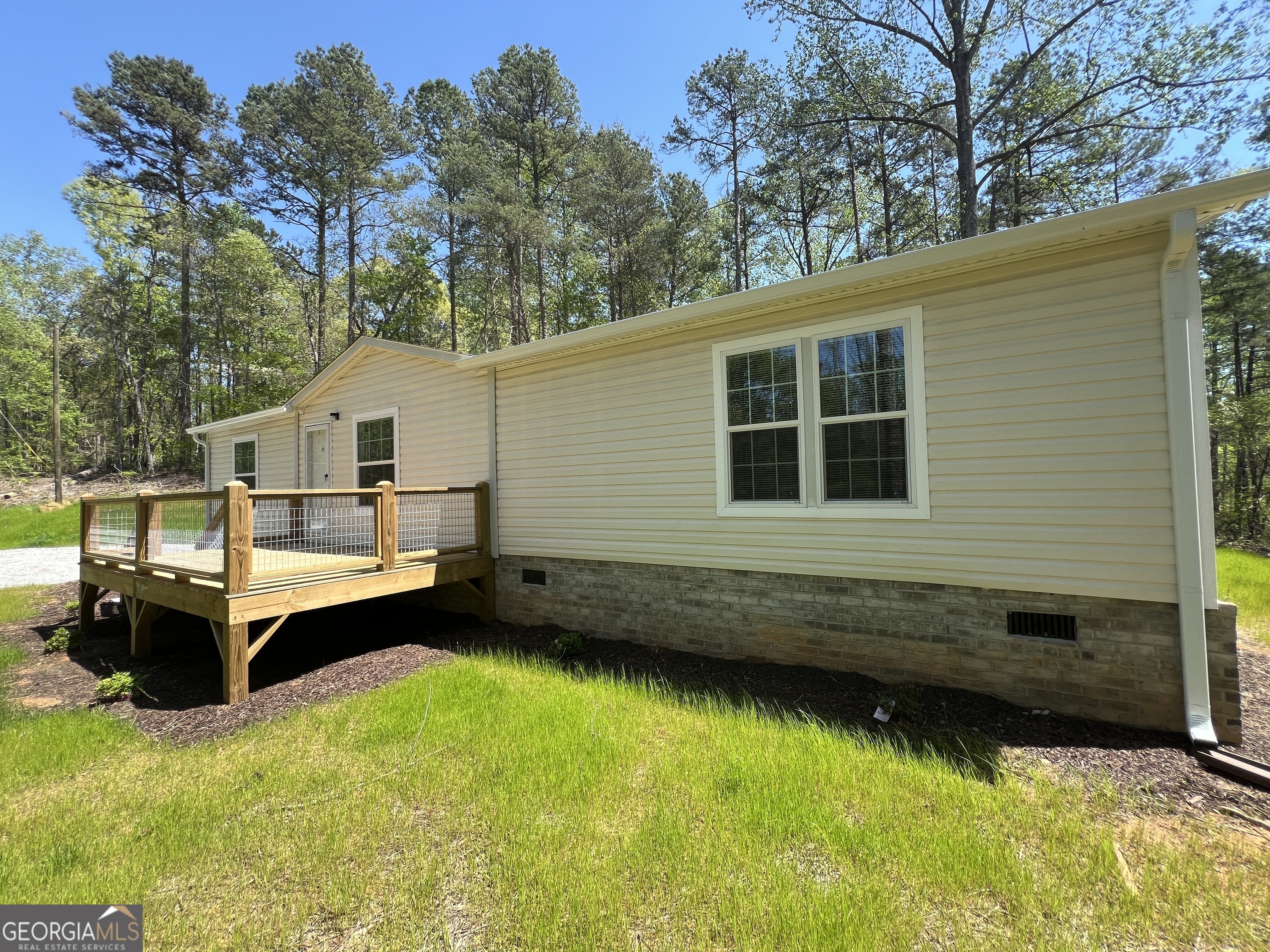 69 Cheyenne Trail Martin, GA 30557 - Photo 5 of 63 a front view of a house with a yard wooden deck and a large tree