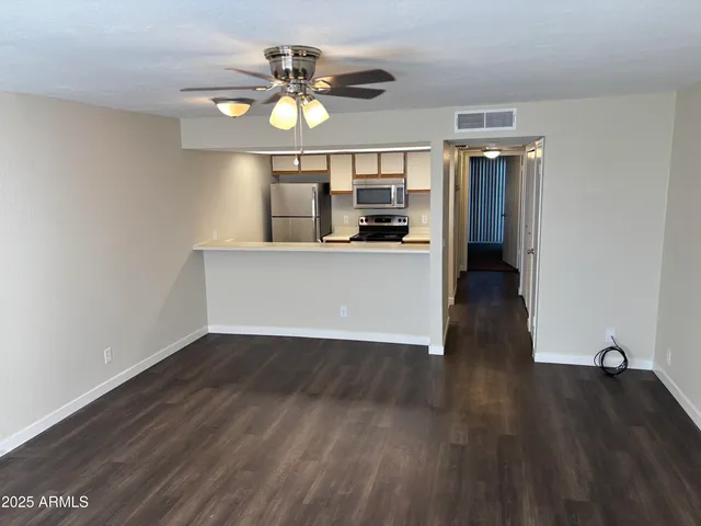 a view of a room with wooden floor and window