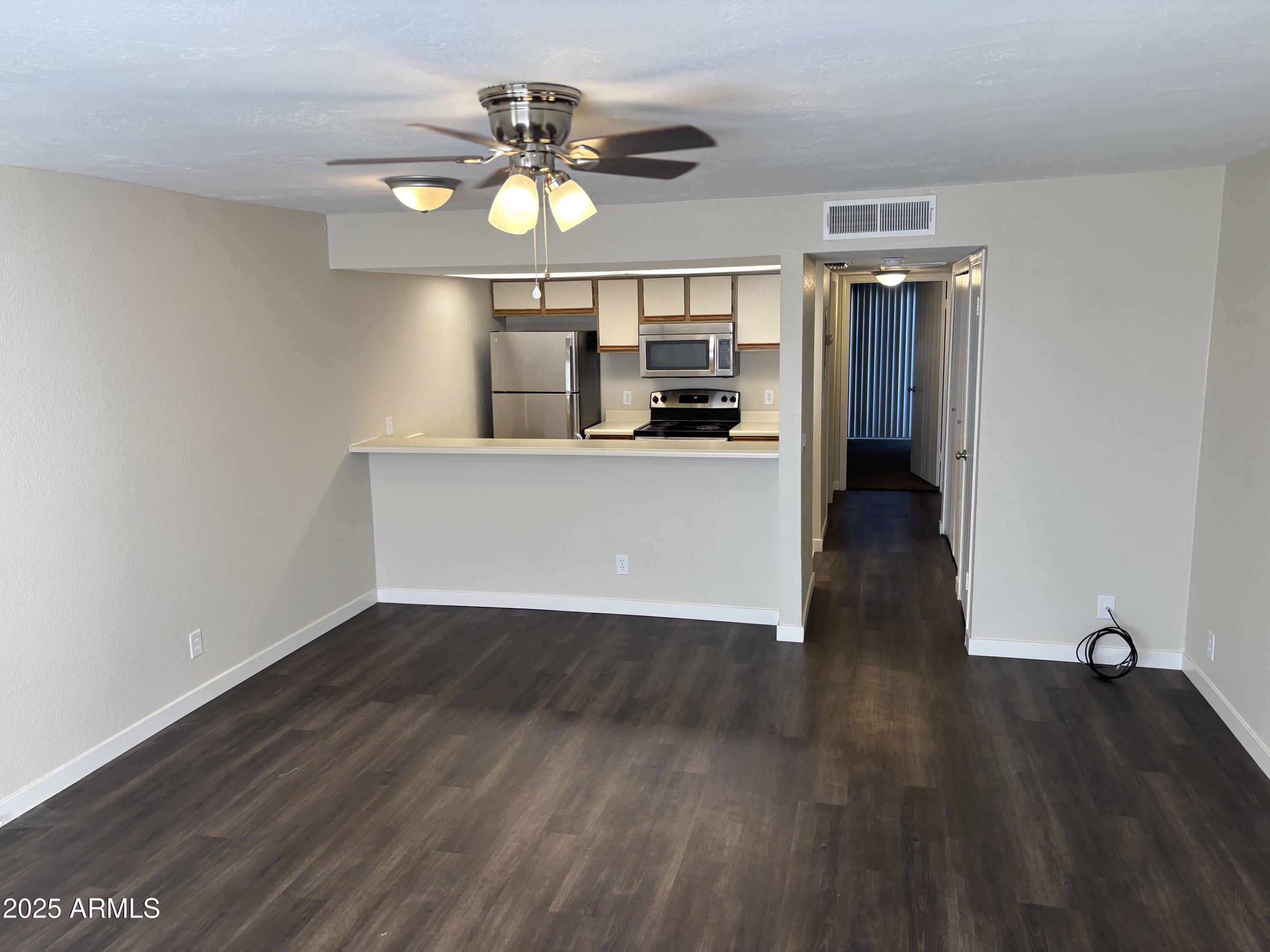 1444 North Recker Road, Unit 118 Mesa, AZ 85205 - Photo 1 of 22 a view of a room with wooden floor and window