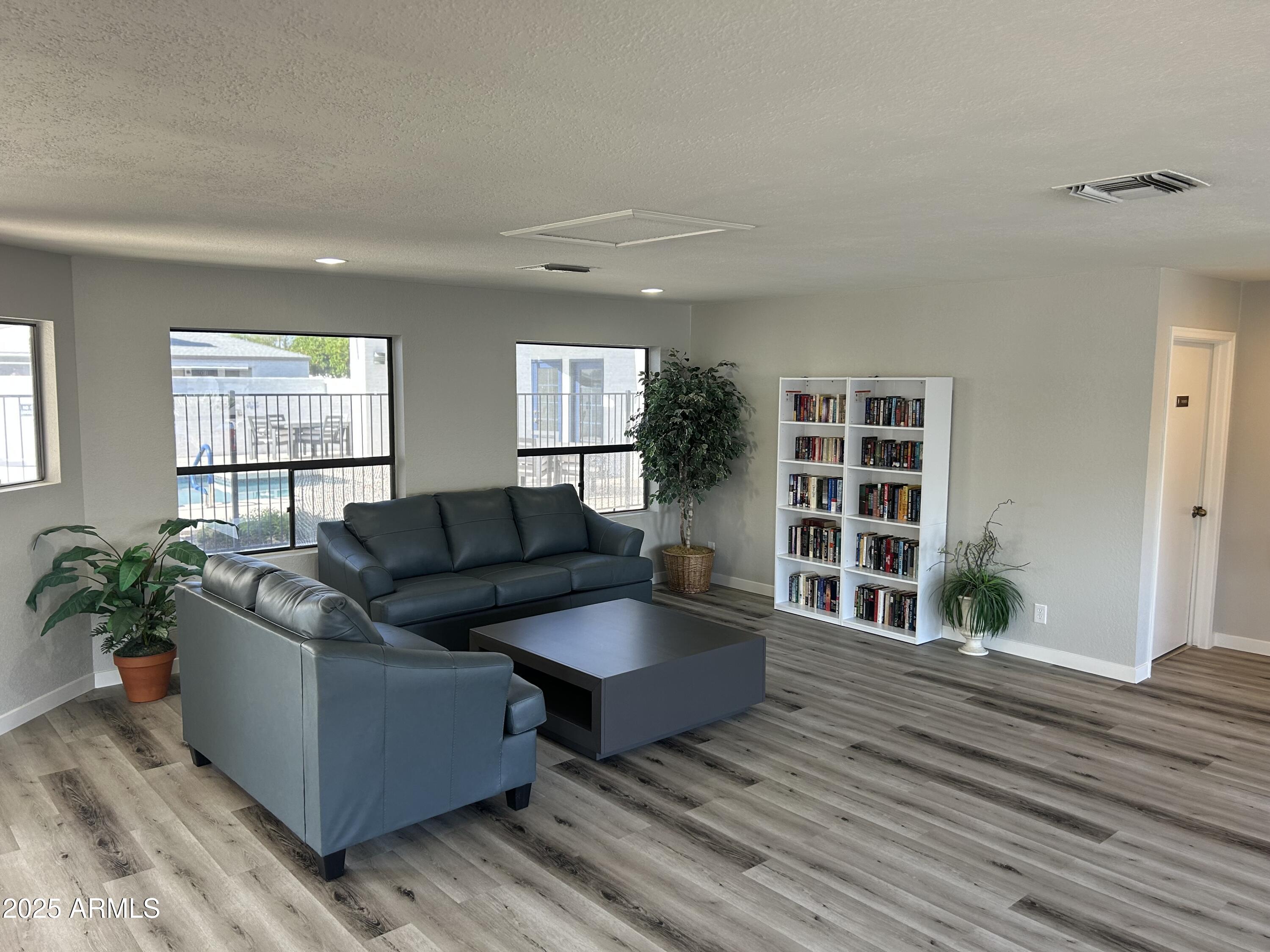 1444 North Recker Road, Unit 118 Mesa, AZ 85205 - Photo 15 of 22 a living room with furniture and a wooden floor
