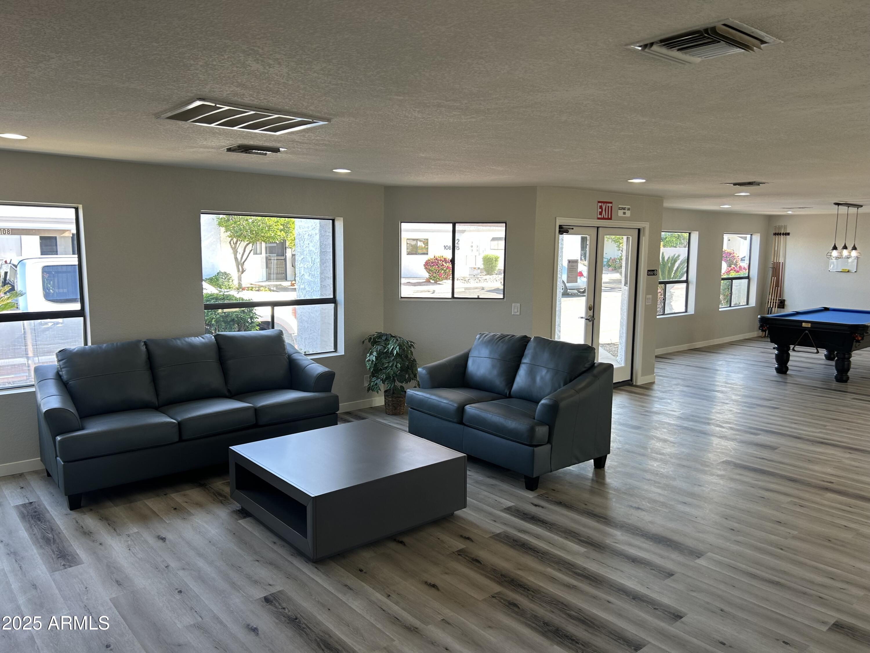 1444 North Recker Road, Unit 118 Mesa, AZ 85205 - Photo 16 of 22 a living room with furniture and a wooden floor