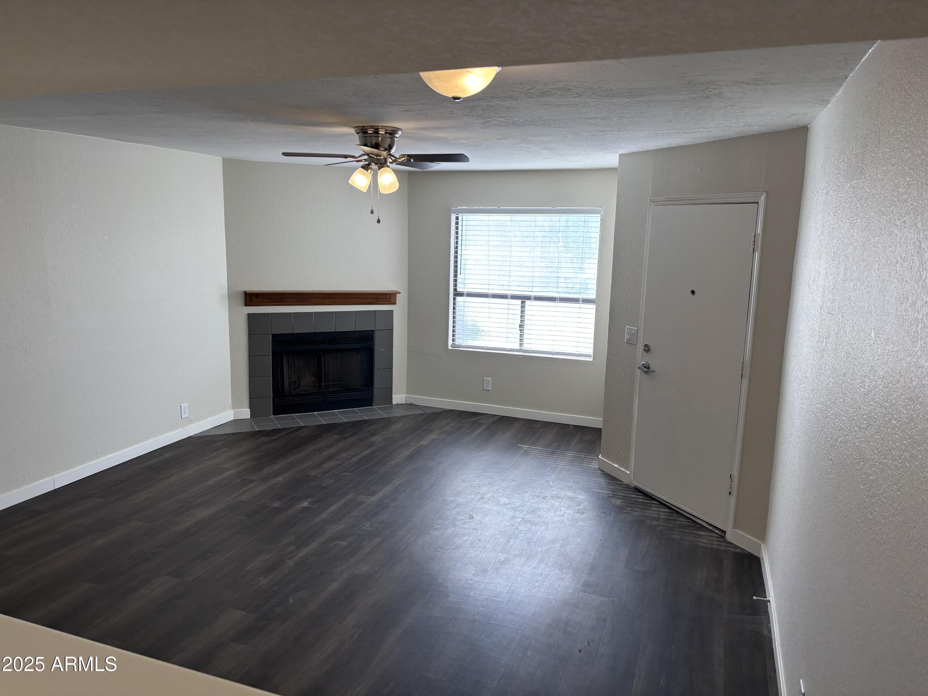 1444 North Recker Road, Unit 118 Mesa, AZ 85205 - Photo 4 of 22 wooden floor in an empty room with a window