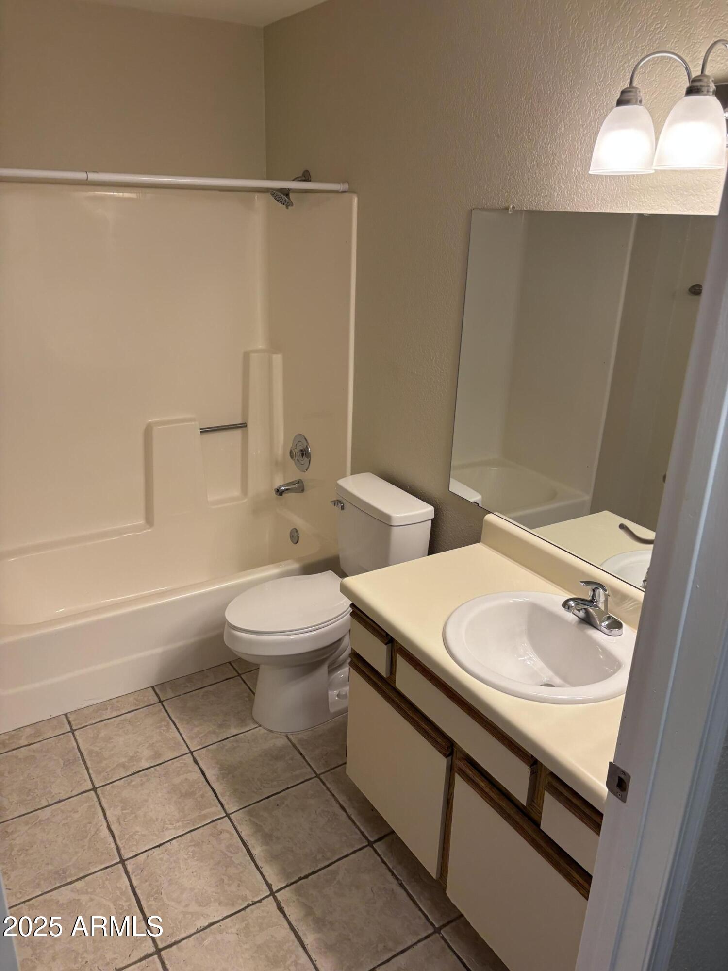 1444 North Recker Road, Unit 118 Mesa, AZ 85205 - Photo 8 of 22 a bathroom with a sink a toilet and a bathtub