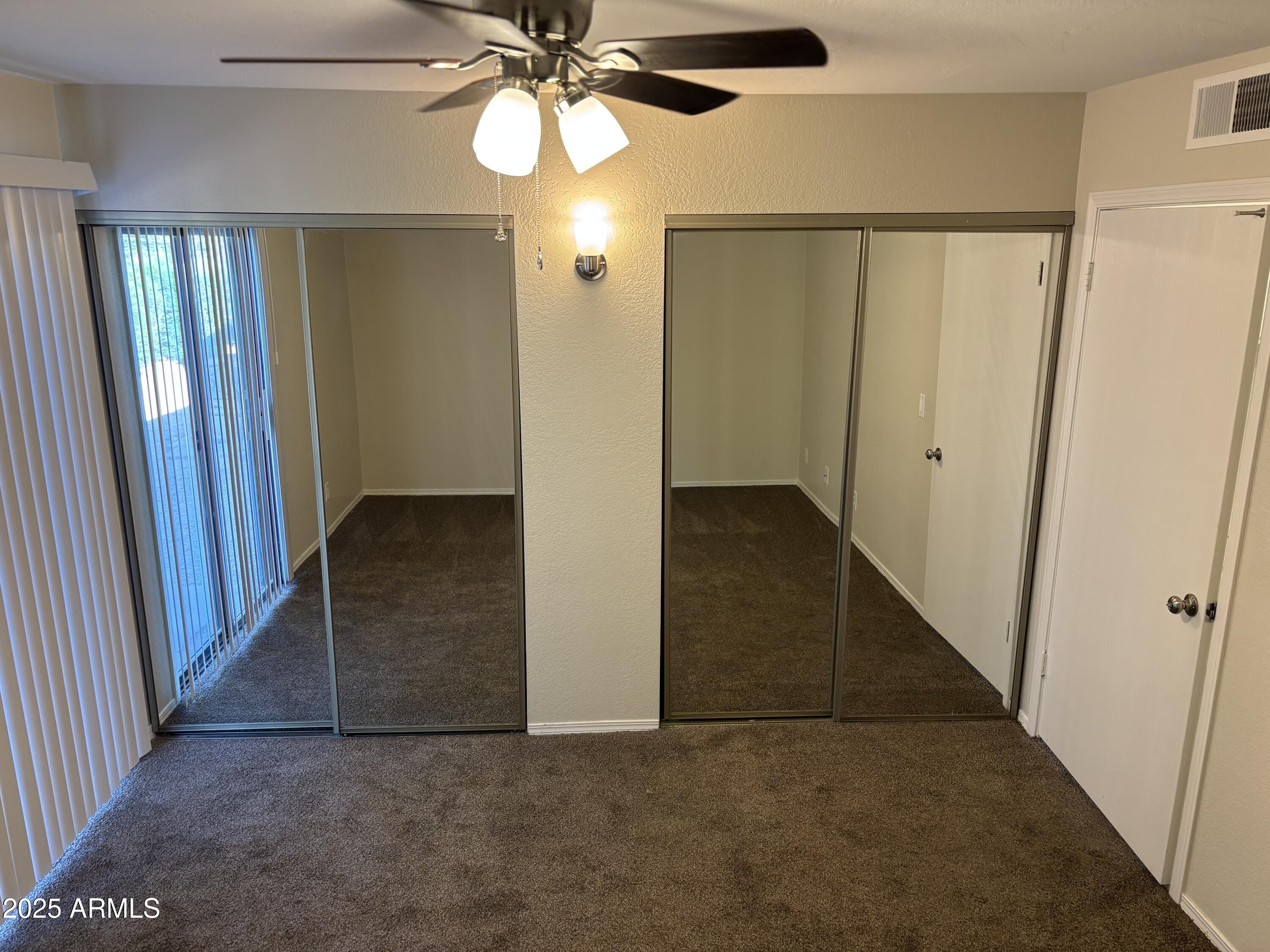 1444 North Recker Road, Unit 118 Mesa, AZ 85205 - Photo 10 of 22 wooden floor in an empty room with a mirror