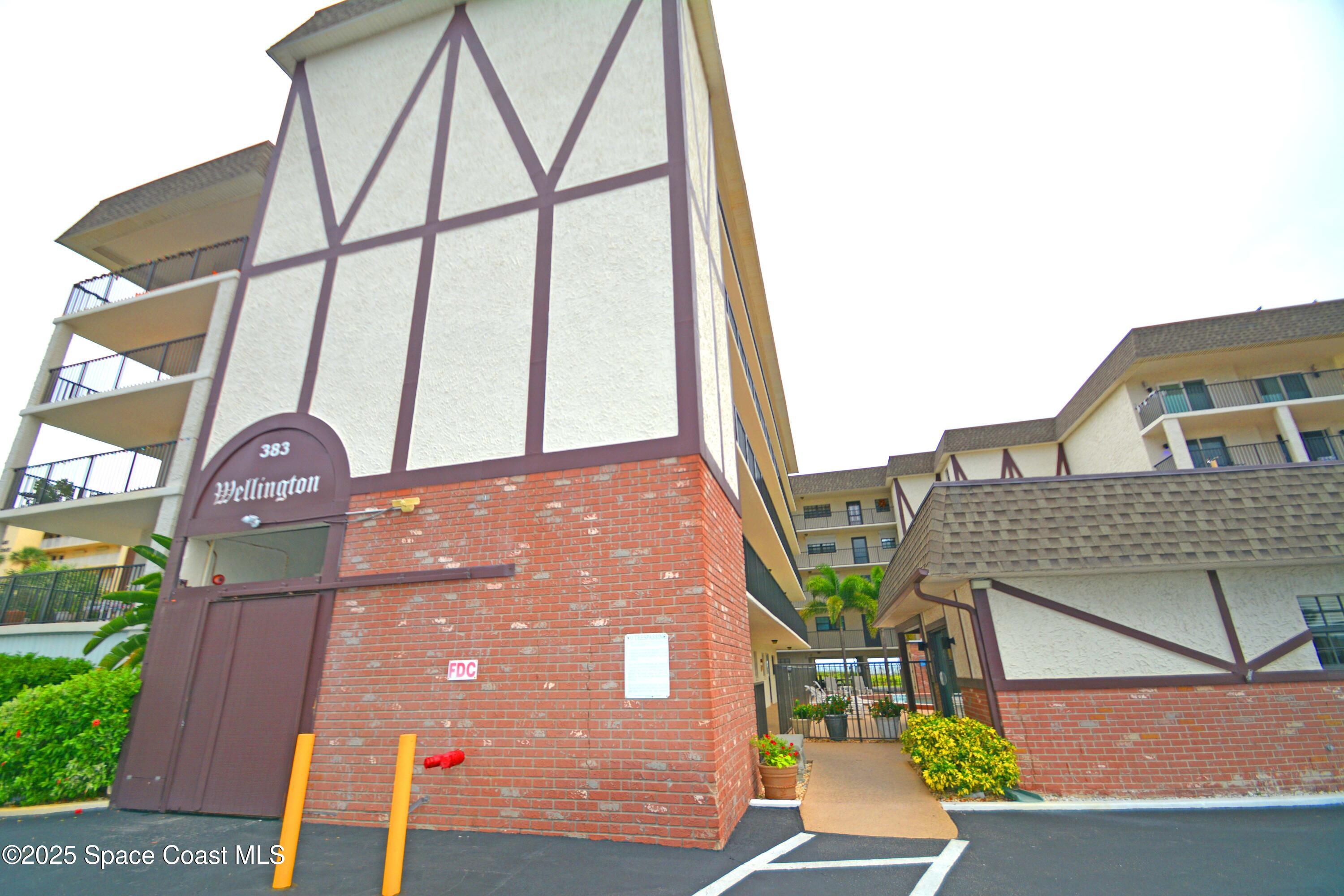 383 North Atlantic Avenue, Unit 105 Cocoa Beach, FL 32931 - Photo 1 of 67 a front view of a house with a yard