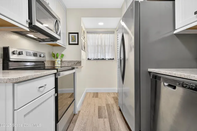 a kitchen with stainless steel appliances granite countertop a sink and cabinets