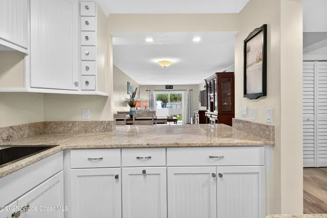a view of a livingroom with furniture and staircase