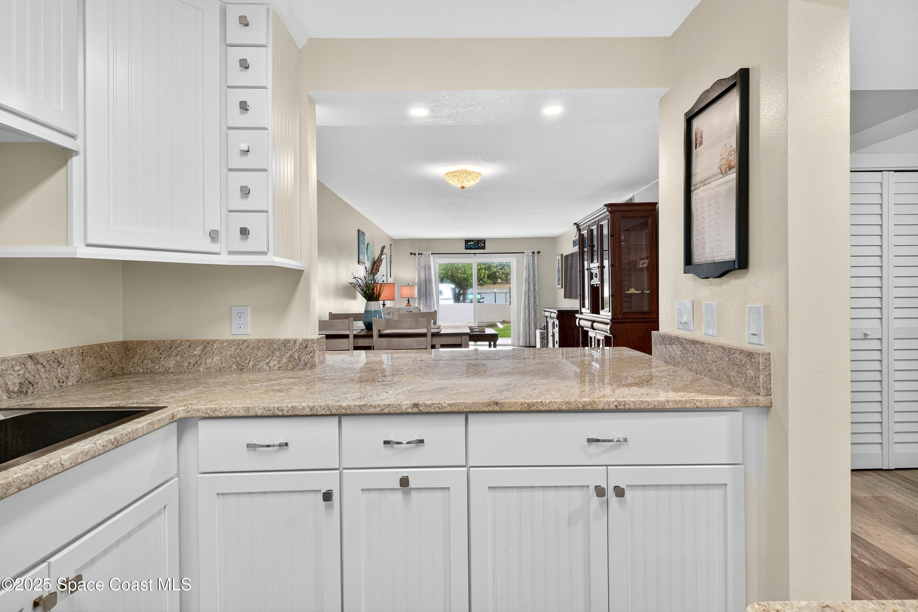 383 North Atlantic Avenue, Unit 105 Cocoa Beach, FL 32931 - Photo 16 of 67 a kitchen with stainless steel appliances granite countertop a sink and cabinets