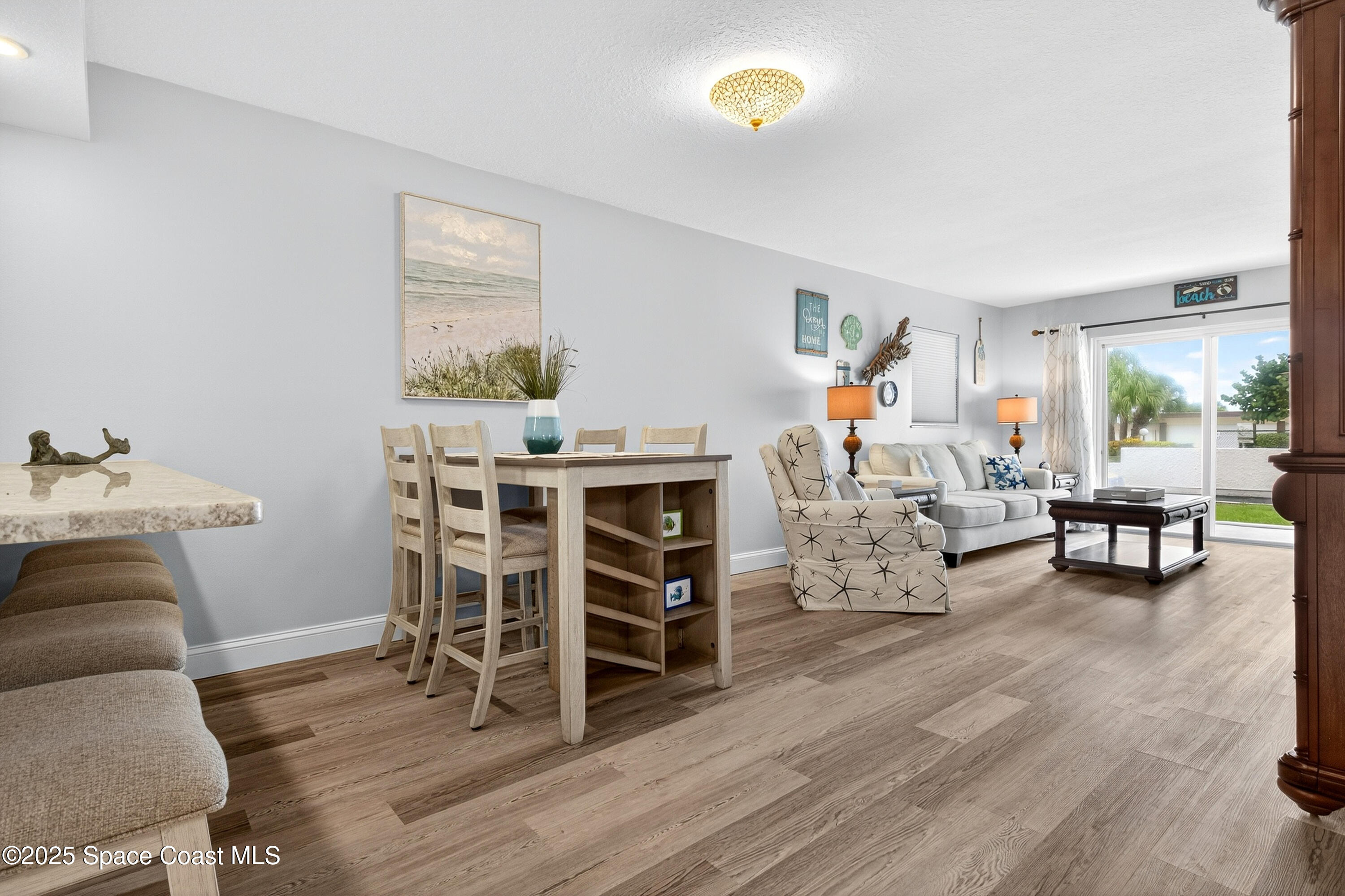 383 North Atlantic Avenue, Unit 105 Cocoa Beach, FL 32931 - Photo 17 of 67 a living room with furniture and wooden floor