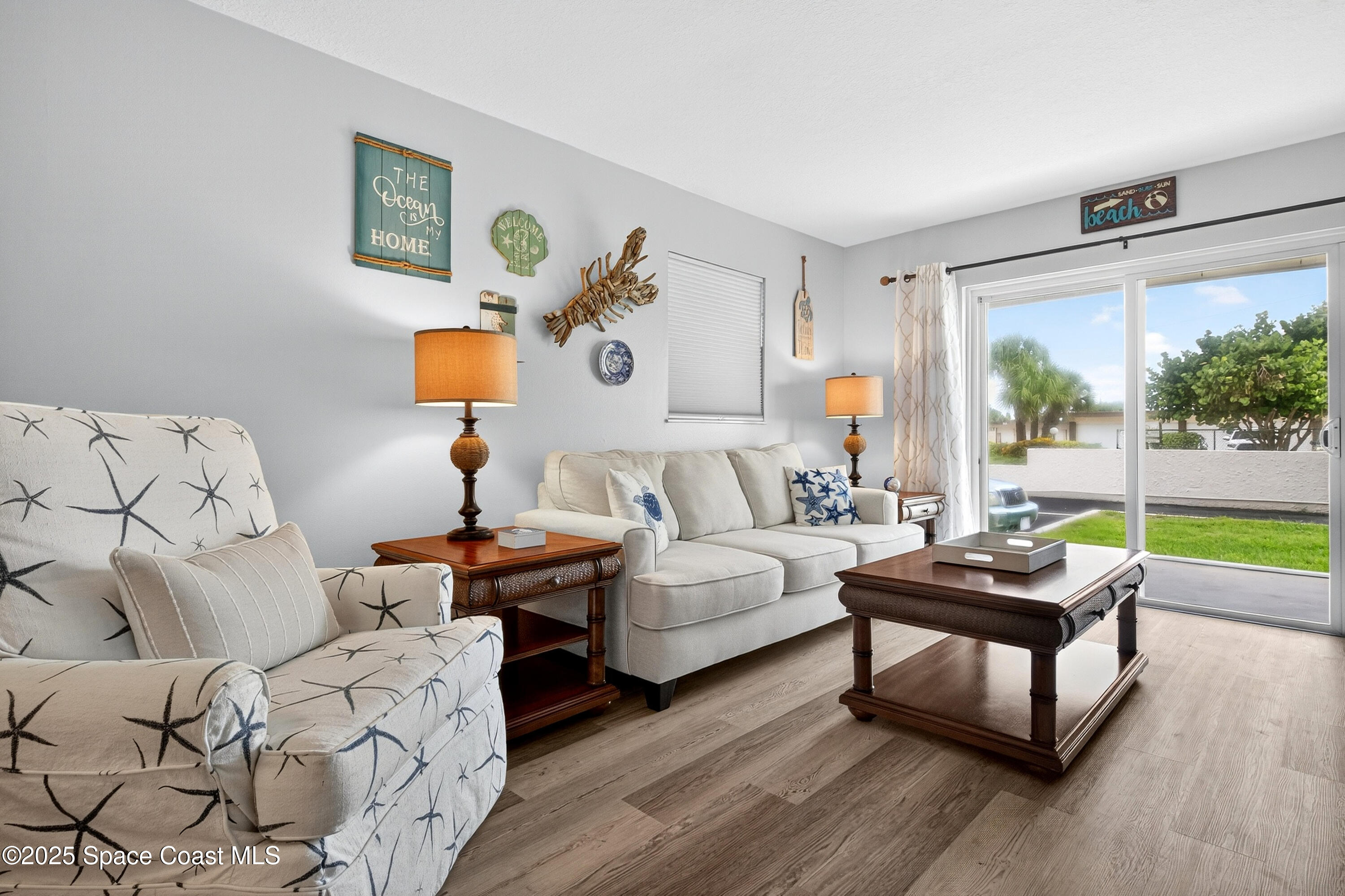 383 North Atlantic Avenue, Unit 105 Cocoa Beach, FL 32931 - Photo 25 of 67 a living room with furniture and a large window