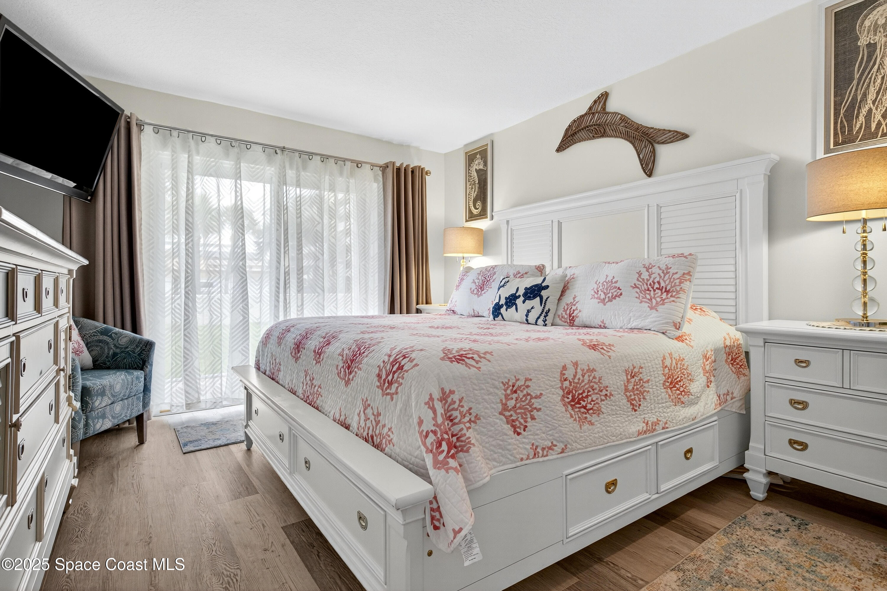 383 North Atlantic Avenue, Unit 105 Cocoa Beach, FL 32931 - Photo 29 of 67 a spacious bedroom with a bed and a couch