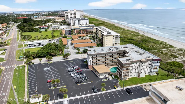 a view of a kitchen with wooden floor and electronic appliances