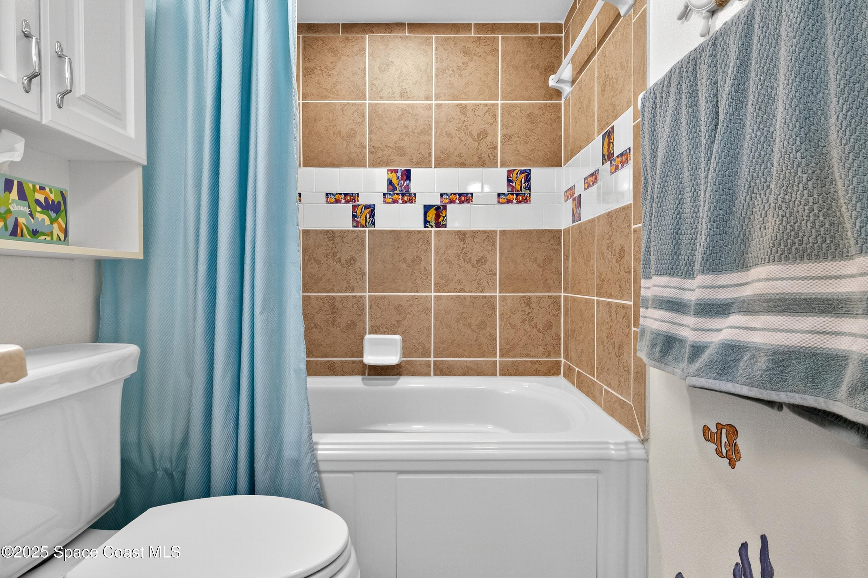 383 North Atlantic Avenue, Unit 105 Cocoa Beach, FL 32931 - Photo 43 of 67 a bathroom with a sink toilet and shower