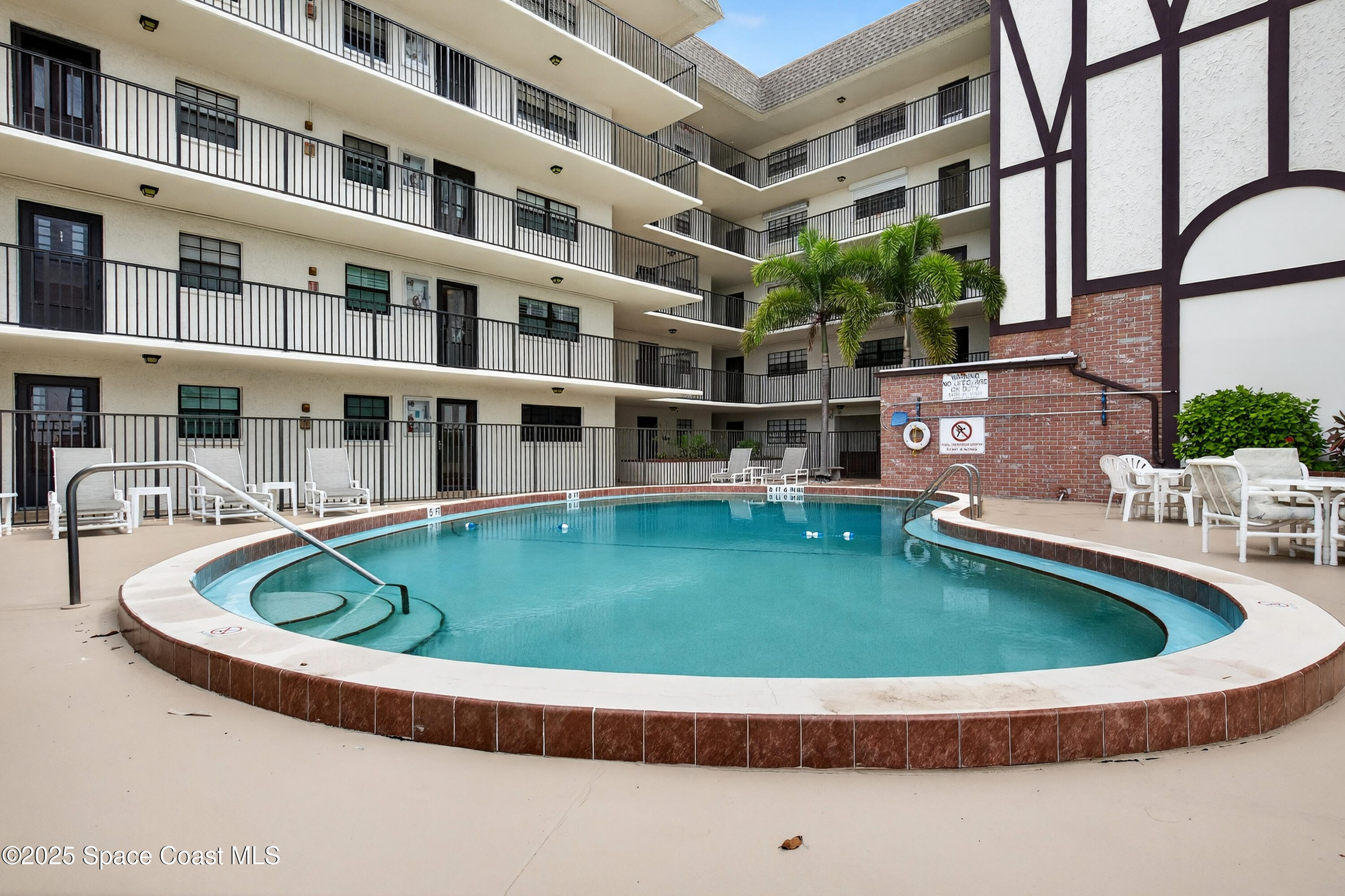 383 North Atlantic Avenue, Unit 105 Cocoa Beach, FL 32931 - Photo 46 of 67 a view of pool with outdoor seating